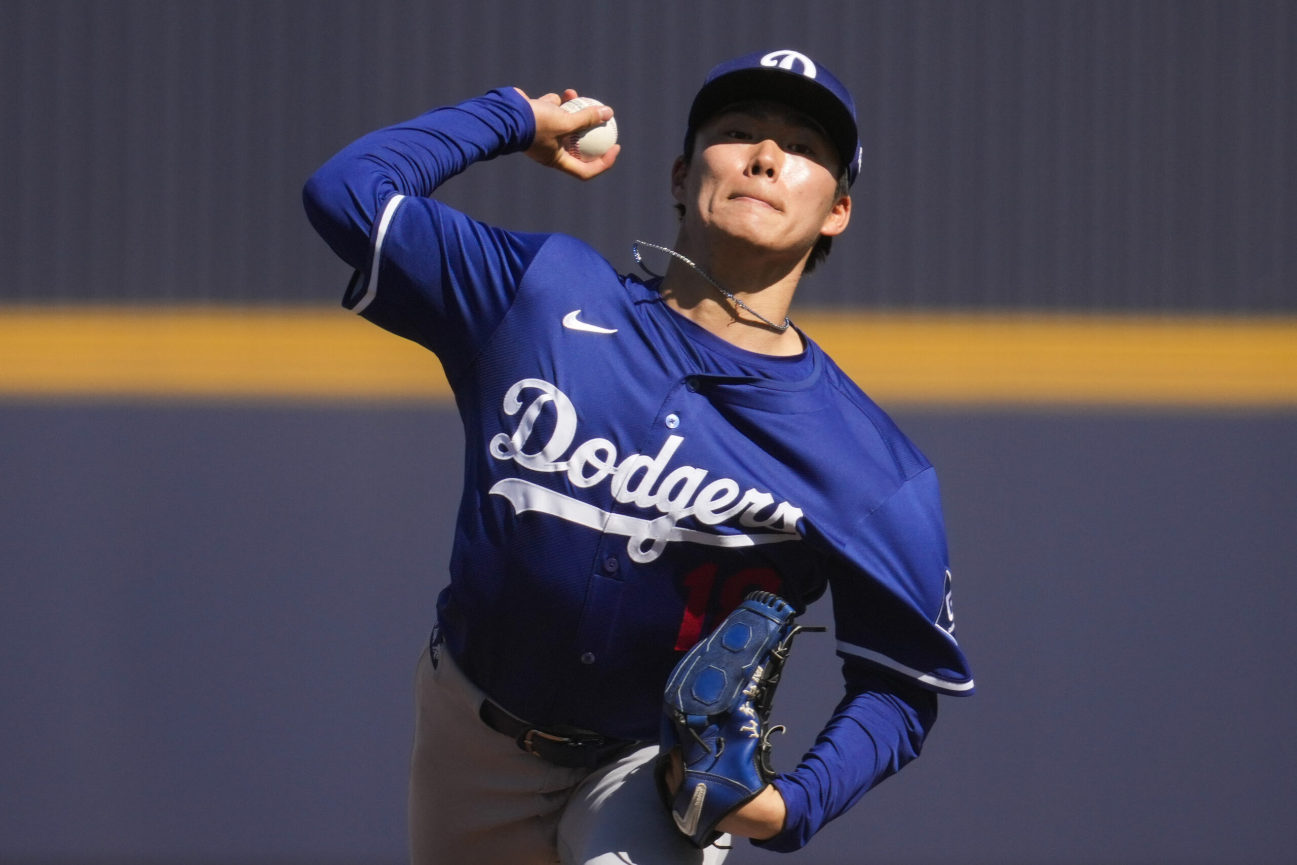 Dodgers starting pitcher Yoshinobu Yamamoto throws during the second inning...