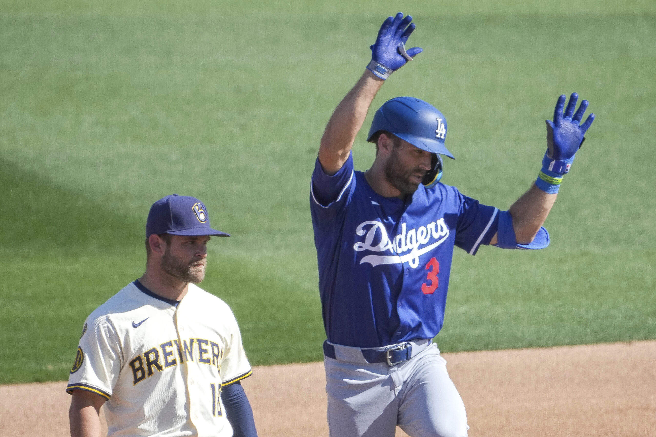 The Dodgers Chris Taylor, right, celebrates behind Milwaukee Brewers third...