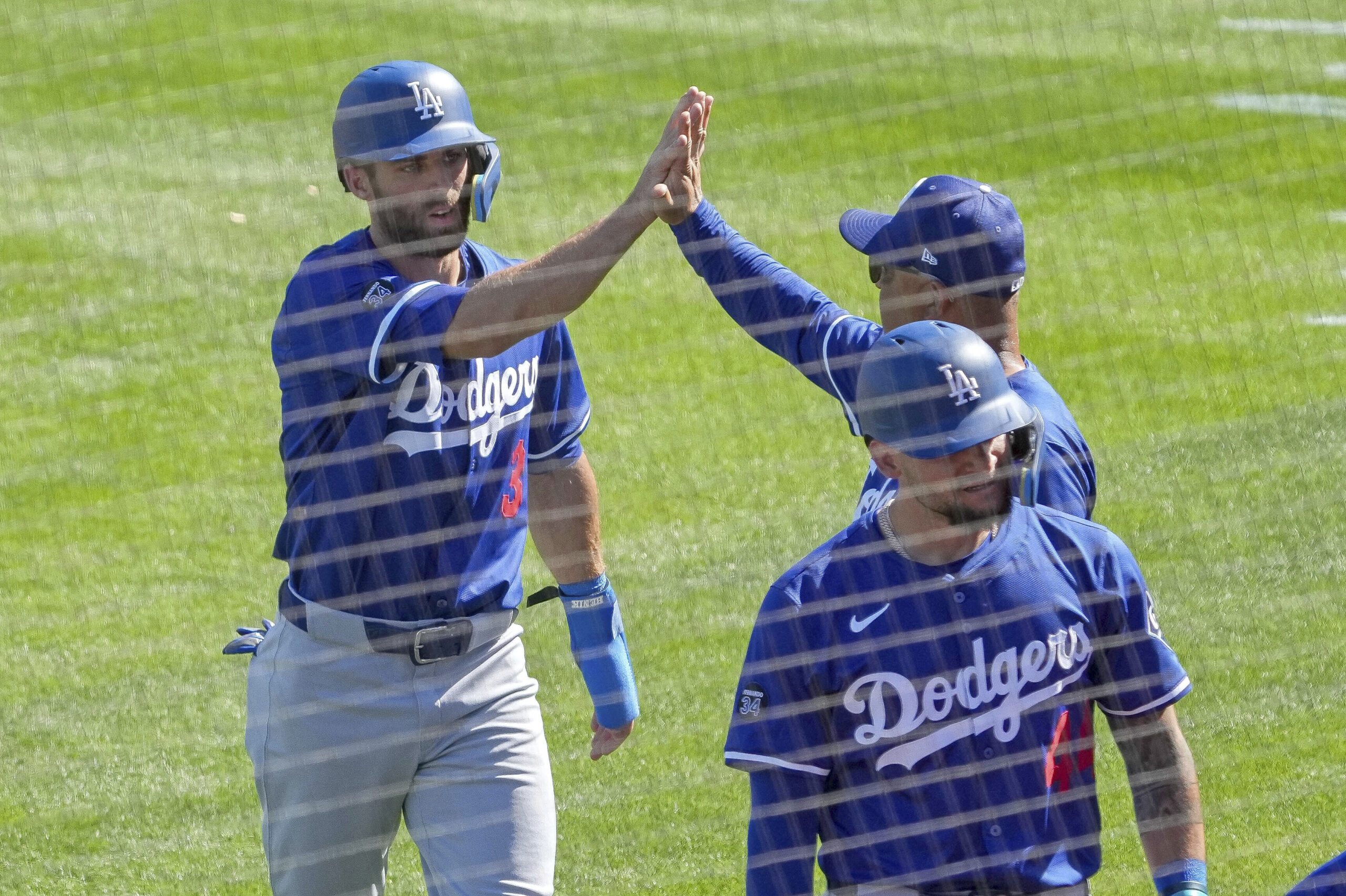 The Dodgers’ Chris Taylor, left, gets a high-five from Manager...