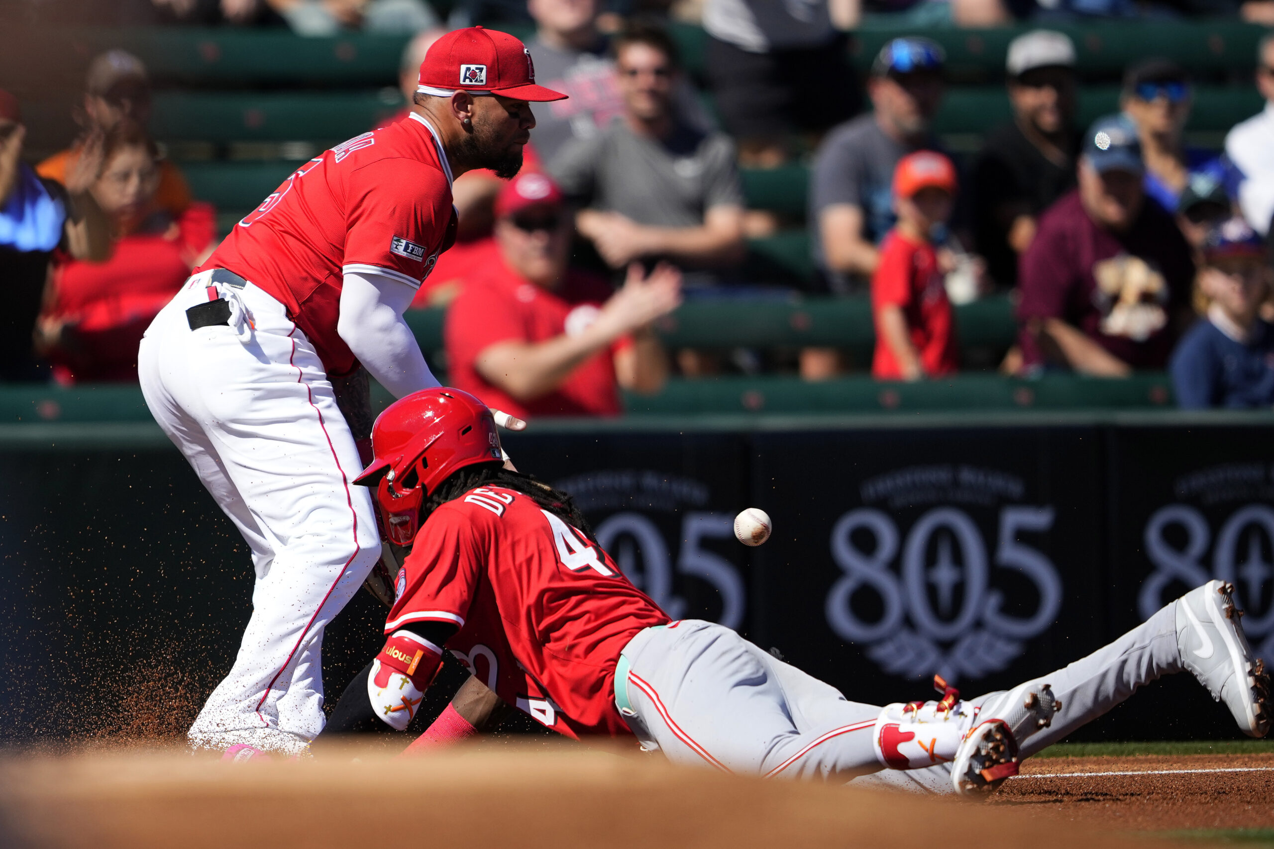 The Cincinnati Reds’ Elly De La Cruz slides in safely...