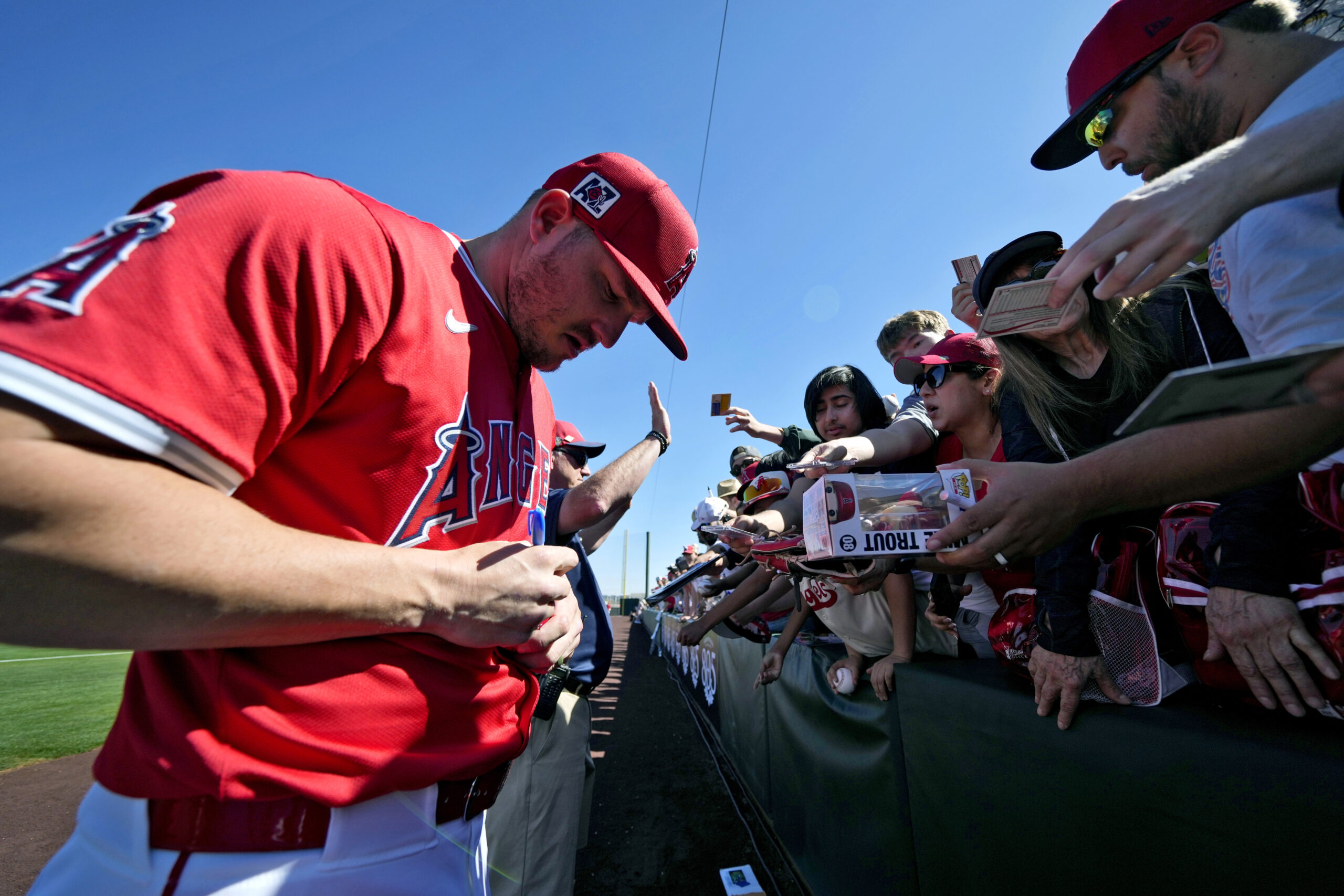 Angels star Mike Trout signs autographs prior to a spring...