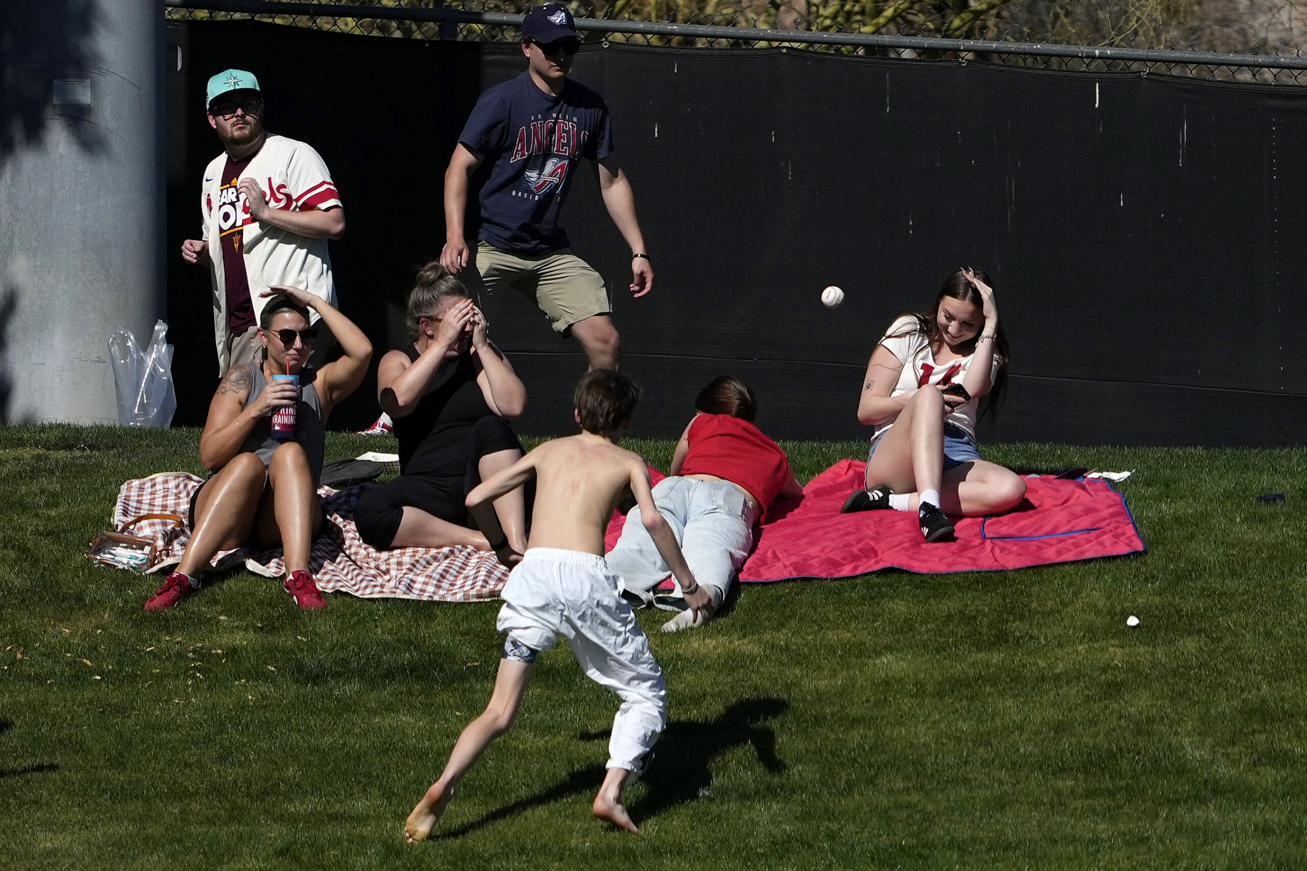 Fans watch Cincinnati Reds’ Christian Encarnacion-Strand’s solo home run ball...