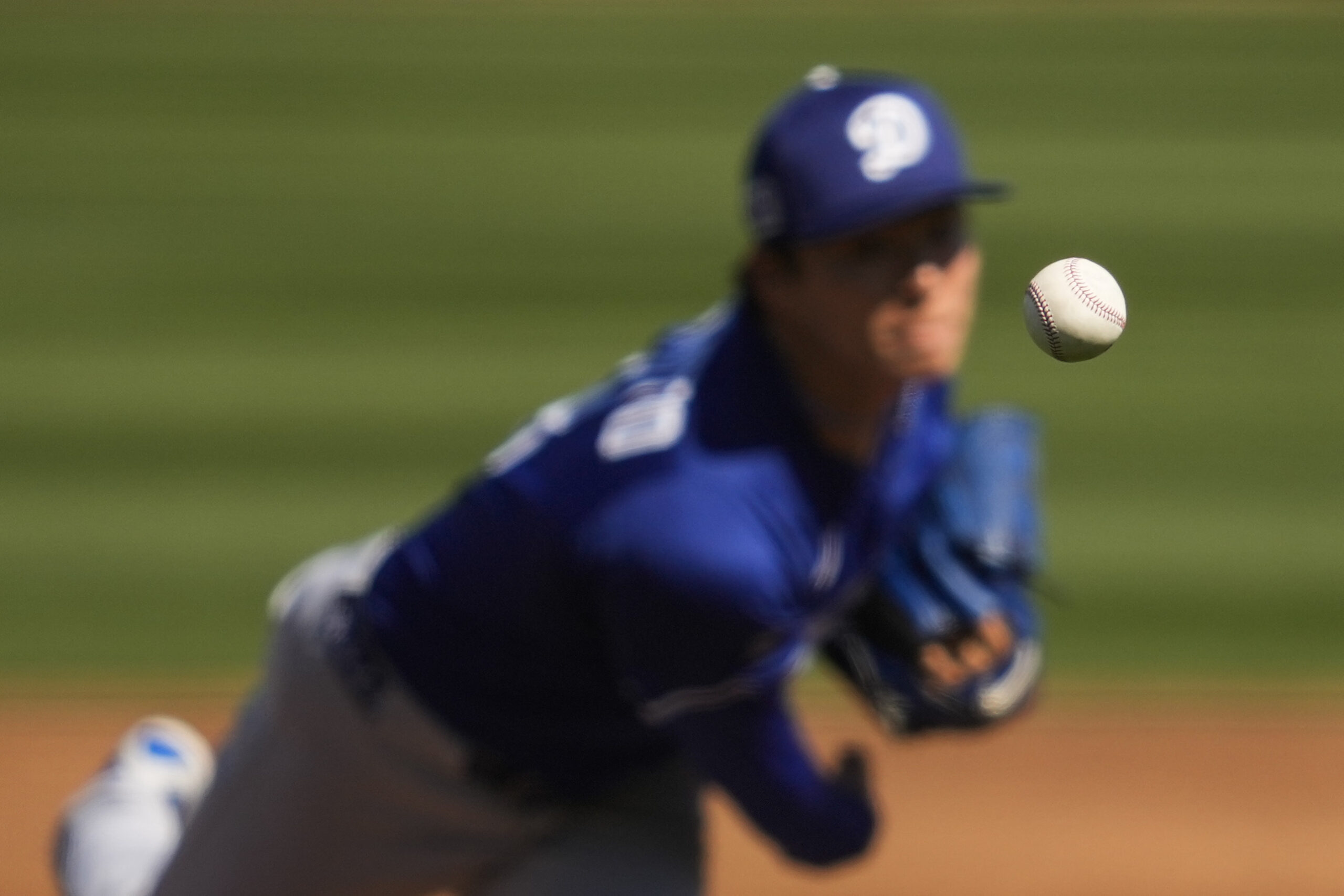 Dodgers starting pitcher Yoshinobu Yamamoto throws during the first inning...