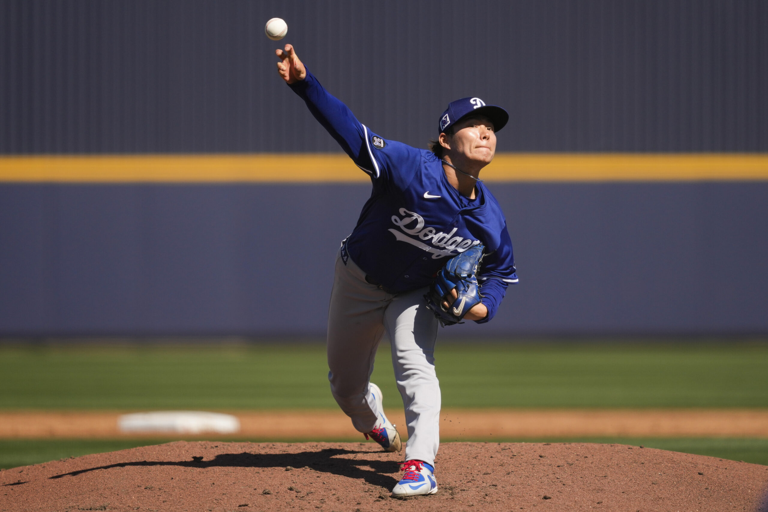 Dodgers starting pitcher Yoshinobu Yamamoto throws during the second inning...