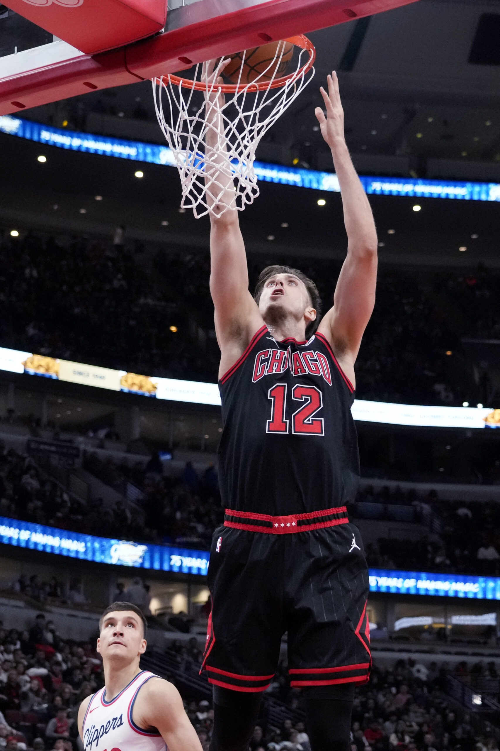 Chicago Bulls forward Zach Collins (12) dunks as Clippers guard...