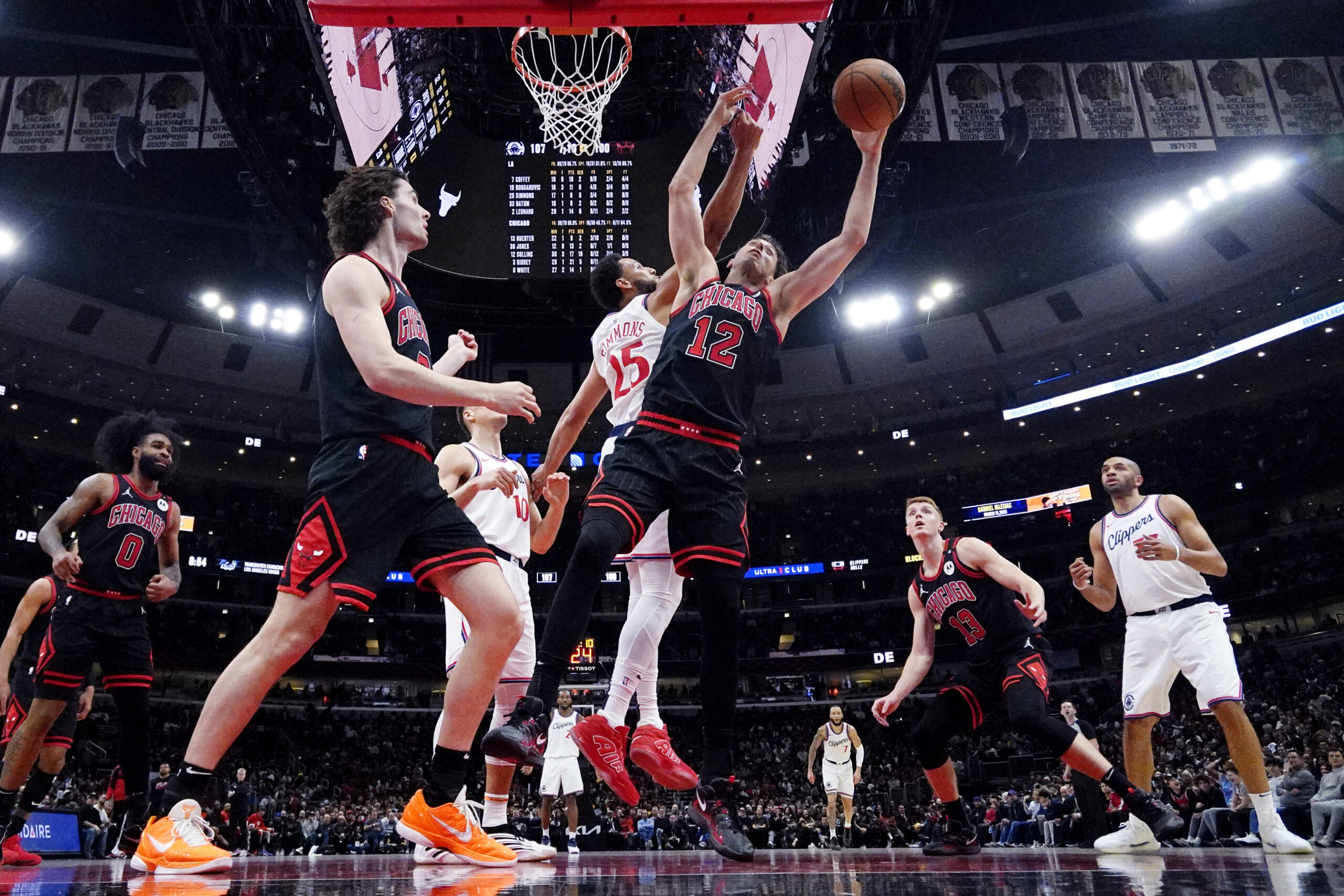 Chicago Bulls forward Zach Collins (12) battles for a rebound...