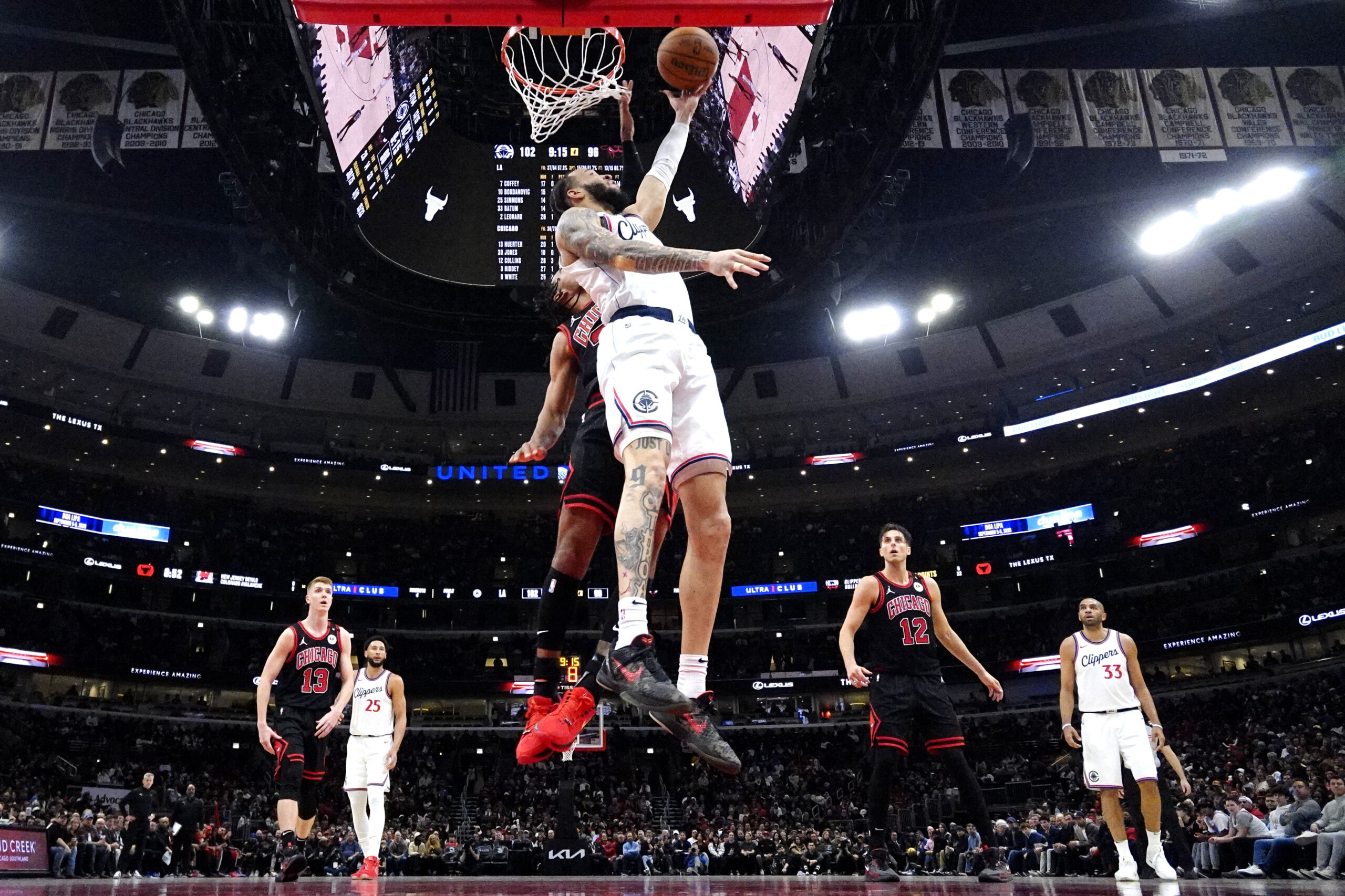 Clippers guard Amir Coffey, right, drives to the basket against...