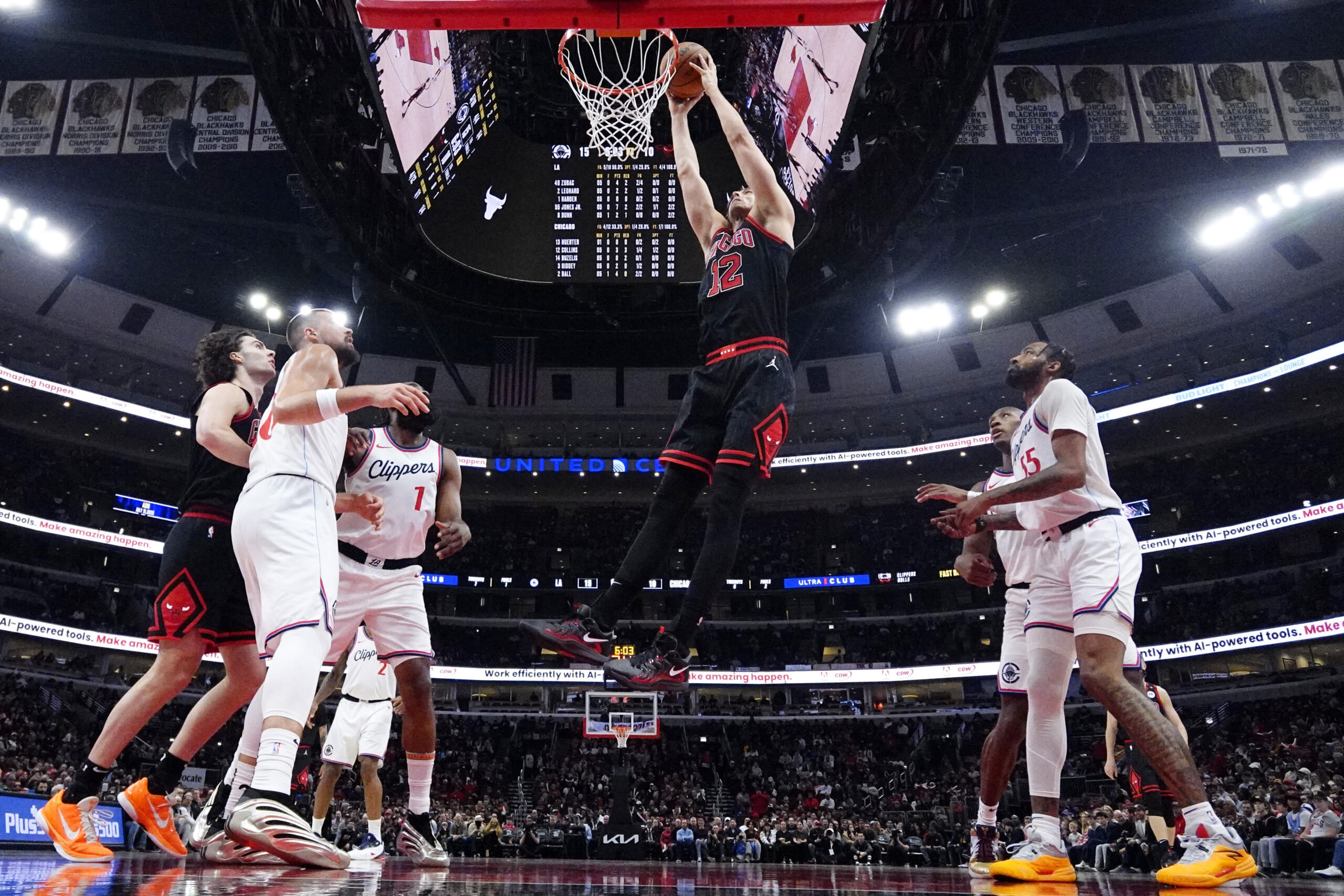 Chicago Bulls forward Zach Collins (12) goes up for a...