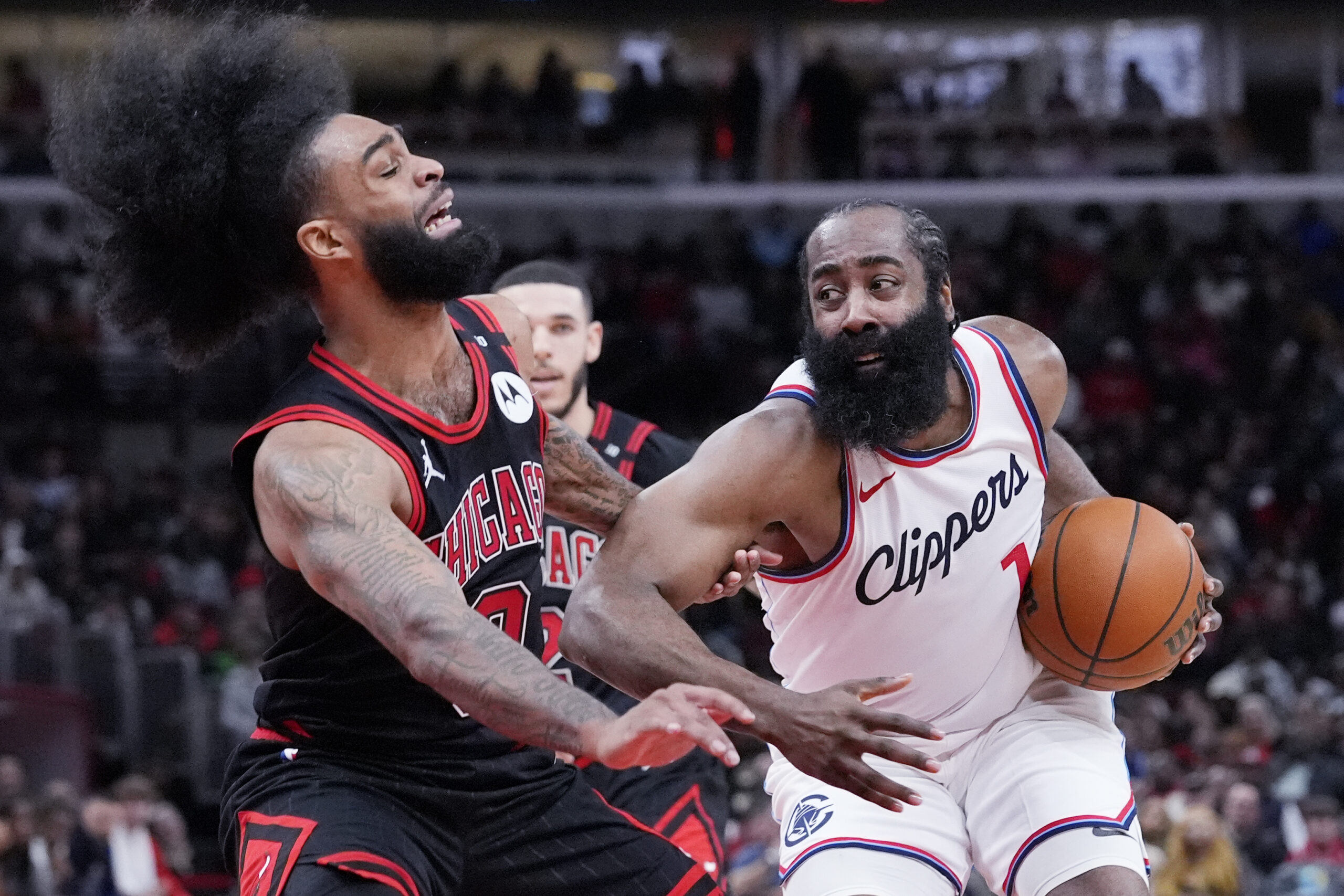 Clippers star James Harden, right, drives as Chicago Bulls guard...