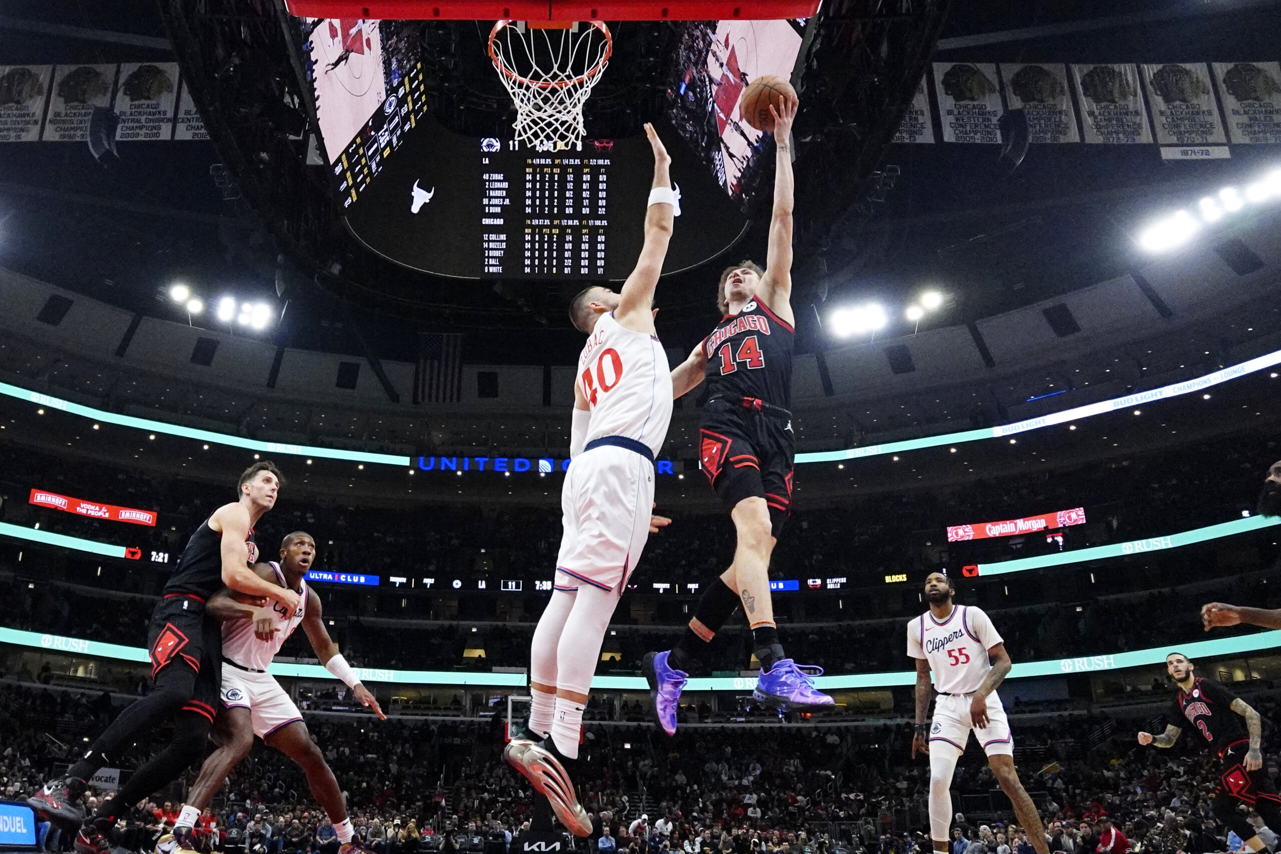 Chicago Bulls forward Matas Buzelis, right, drives to the basket...