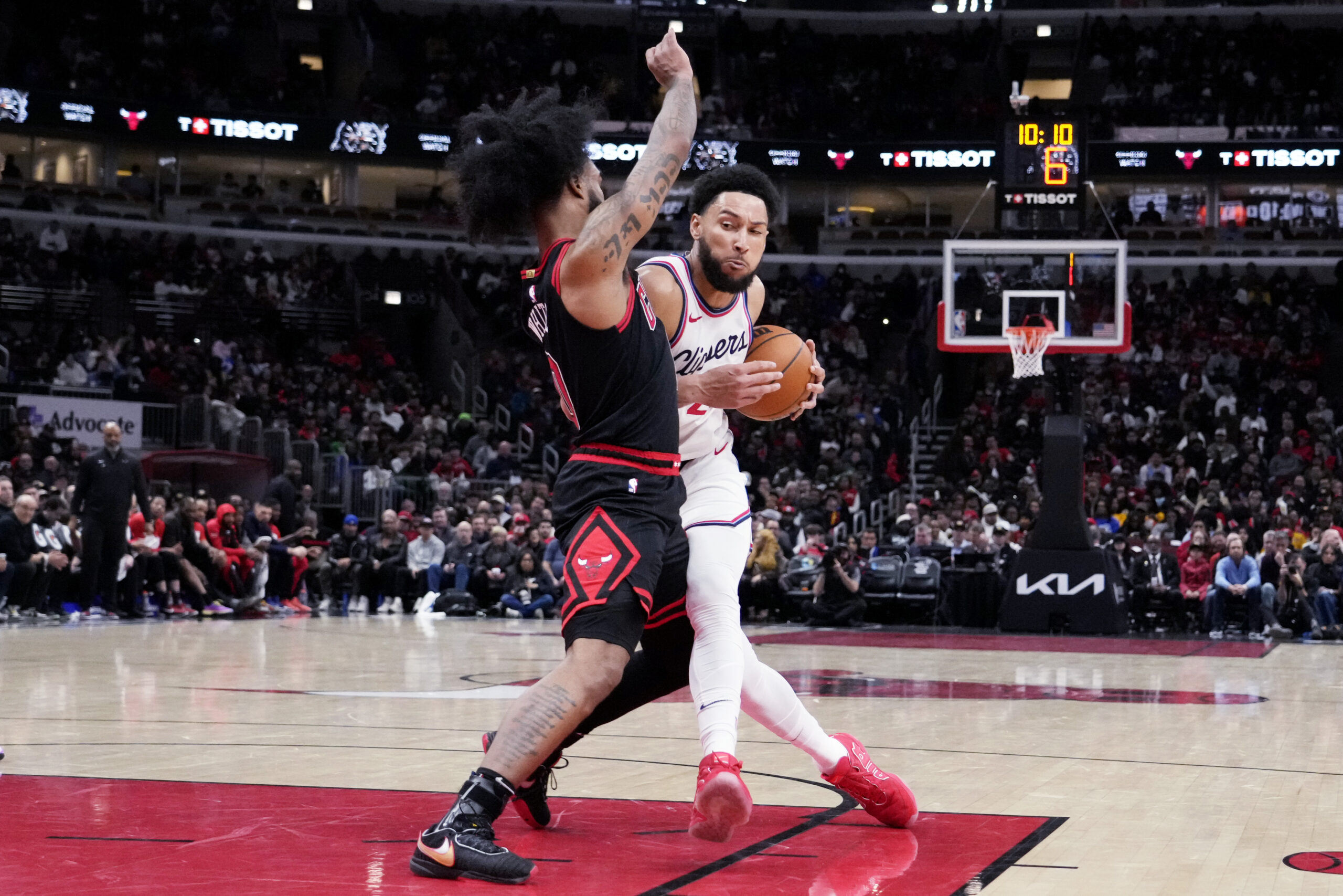 Clippers guard Ben Simmons, right, drives against Chicago Bulls guard...