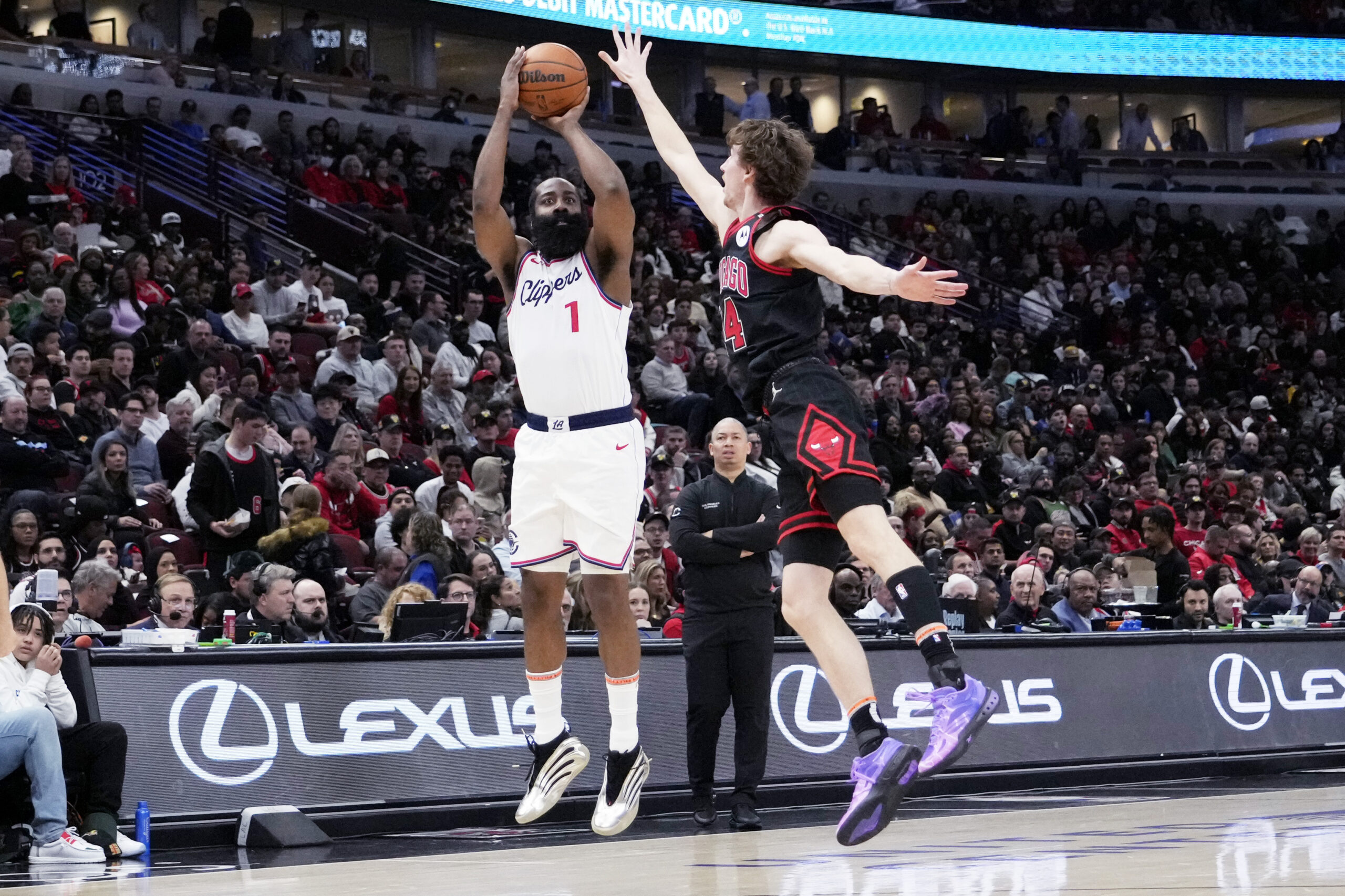 Clippers guard James Harden, left, shoots over Chicago Bulls forward...