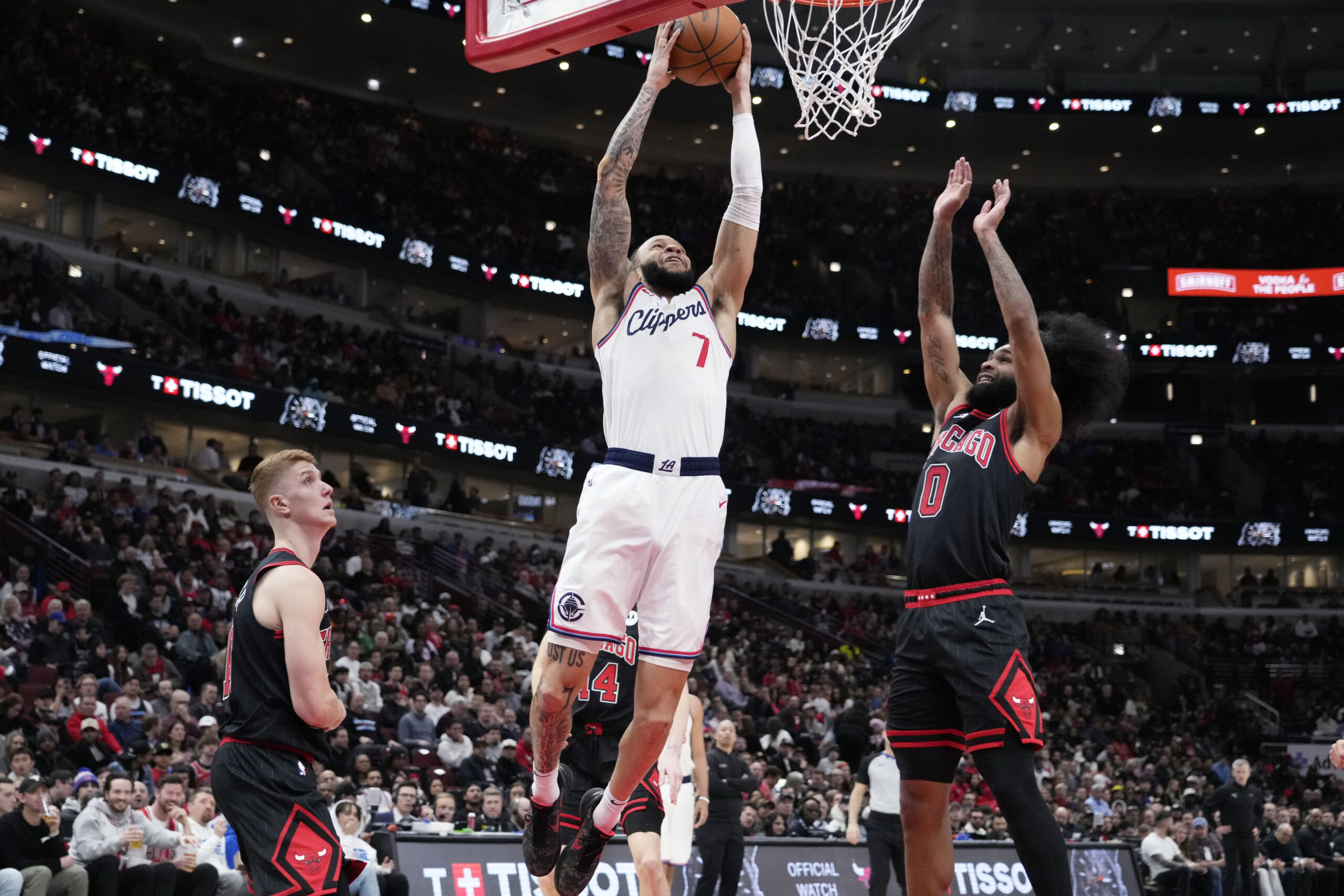 Clippers guard Amir Coffey (7) goes up for a dunk...