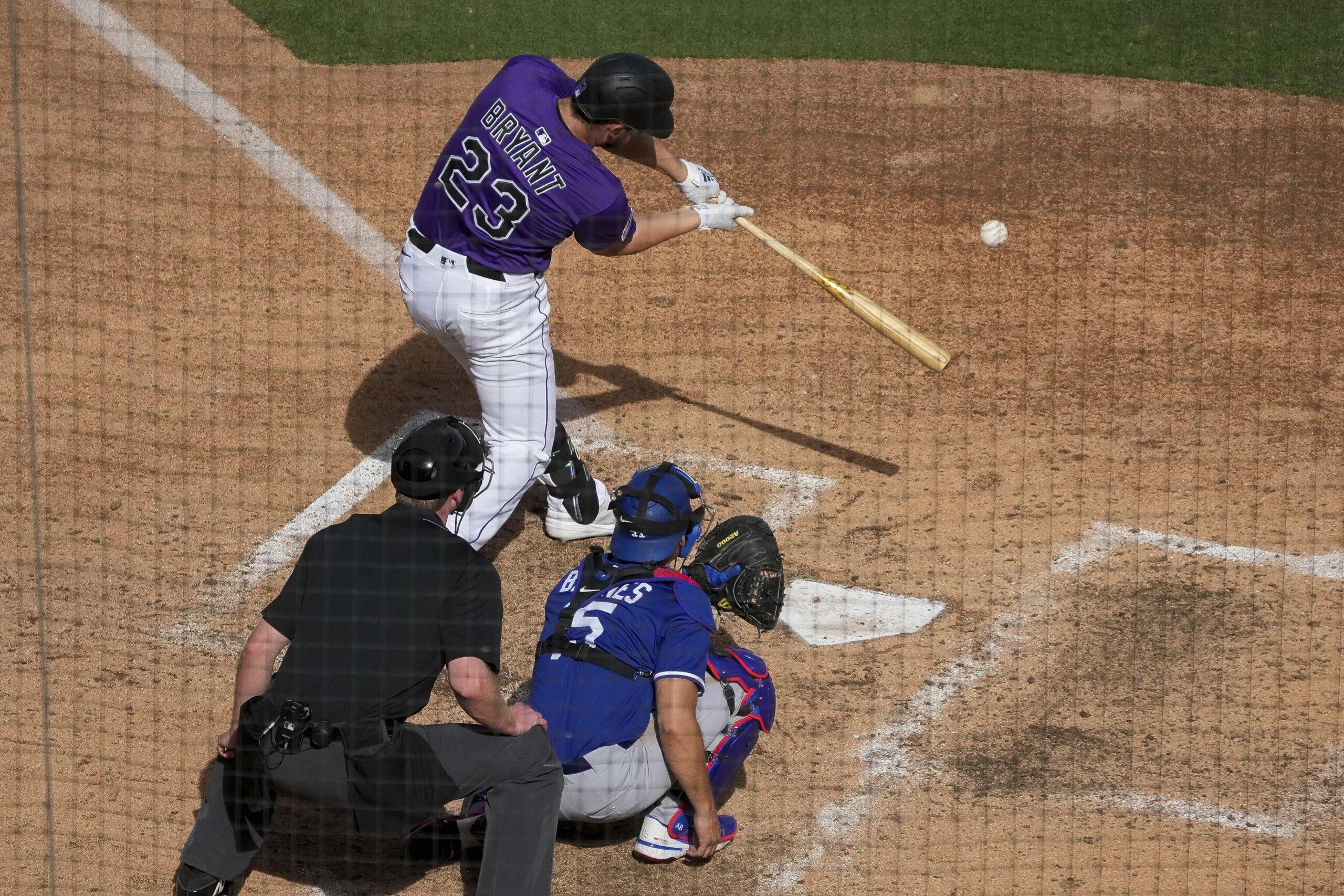 Colorado Rockies outfielder Kris Bryant (23) swings against the Dodgers...