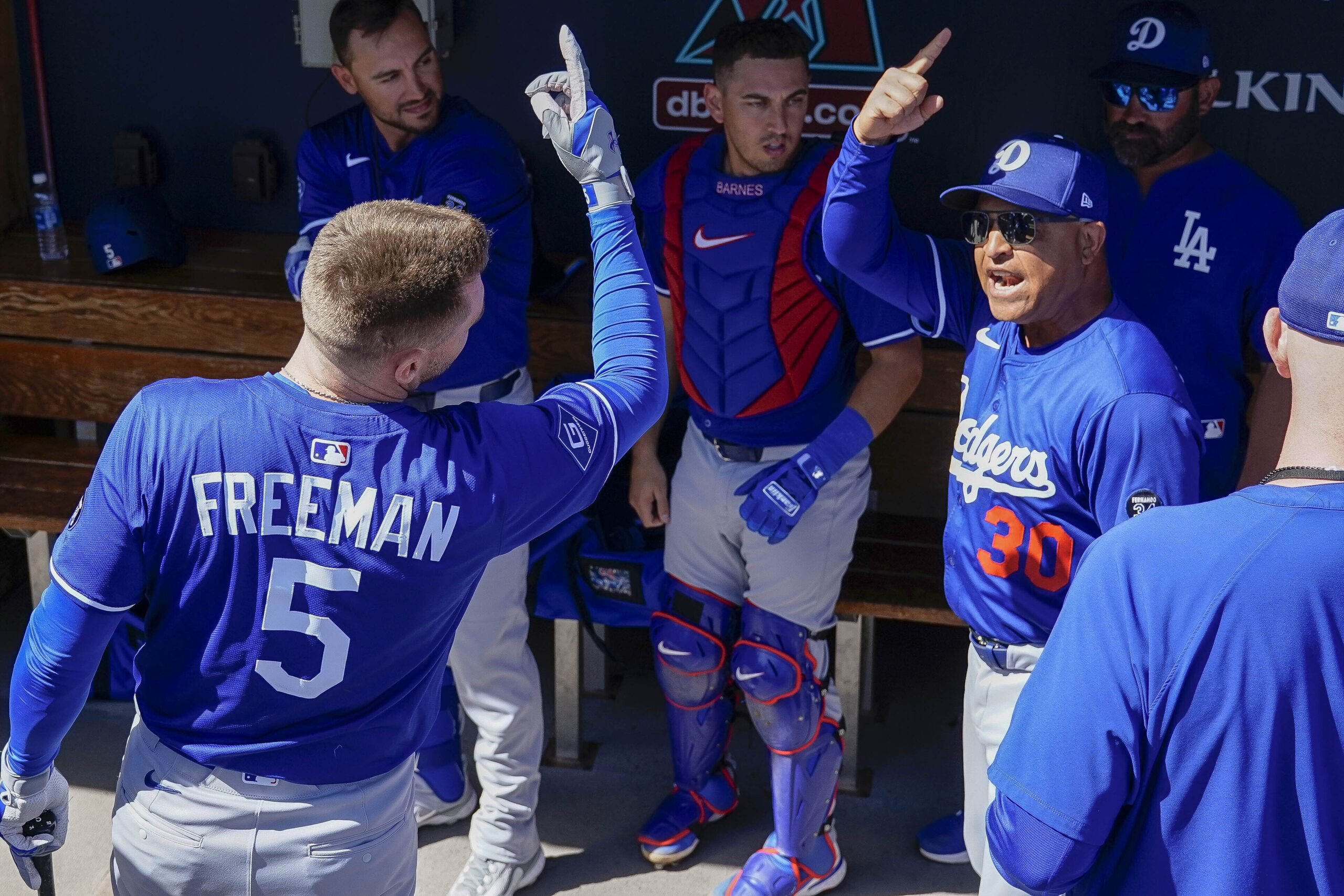 Dodgers first baseman Freddie Freeman, left, and Manager Dave Roberts,...