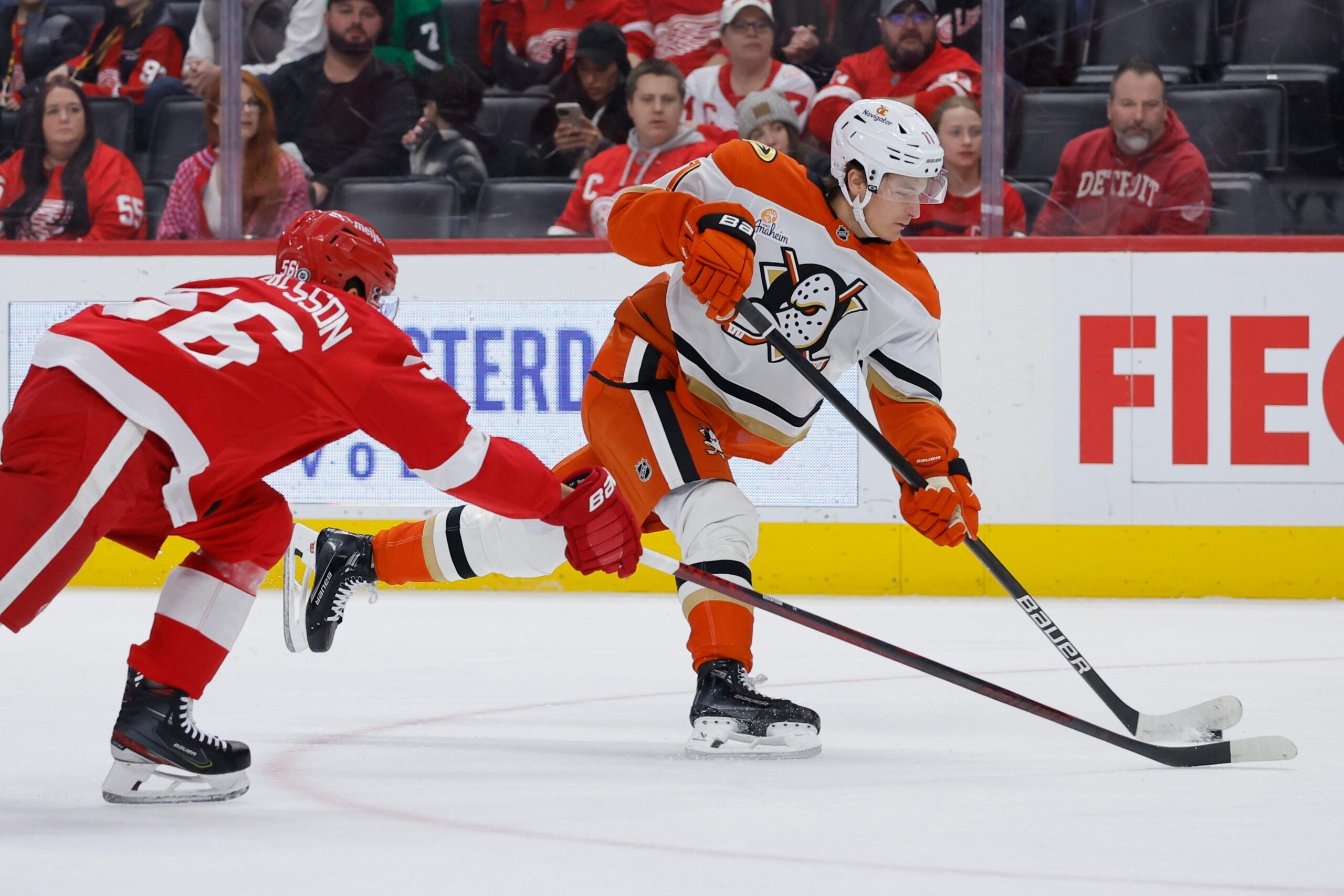 Ducks center Trevor Zegras, right, shoots on goal against Detroit...