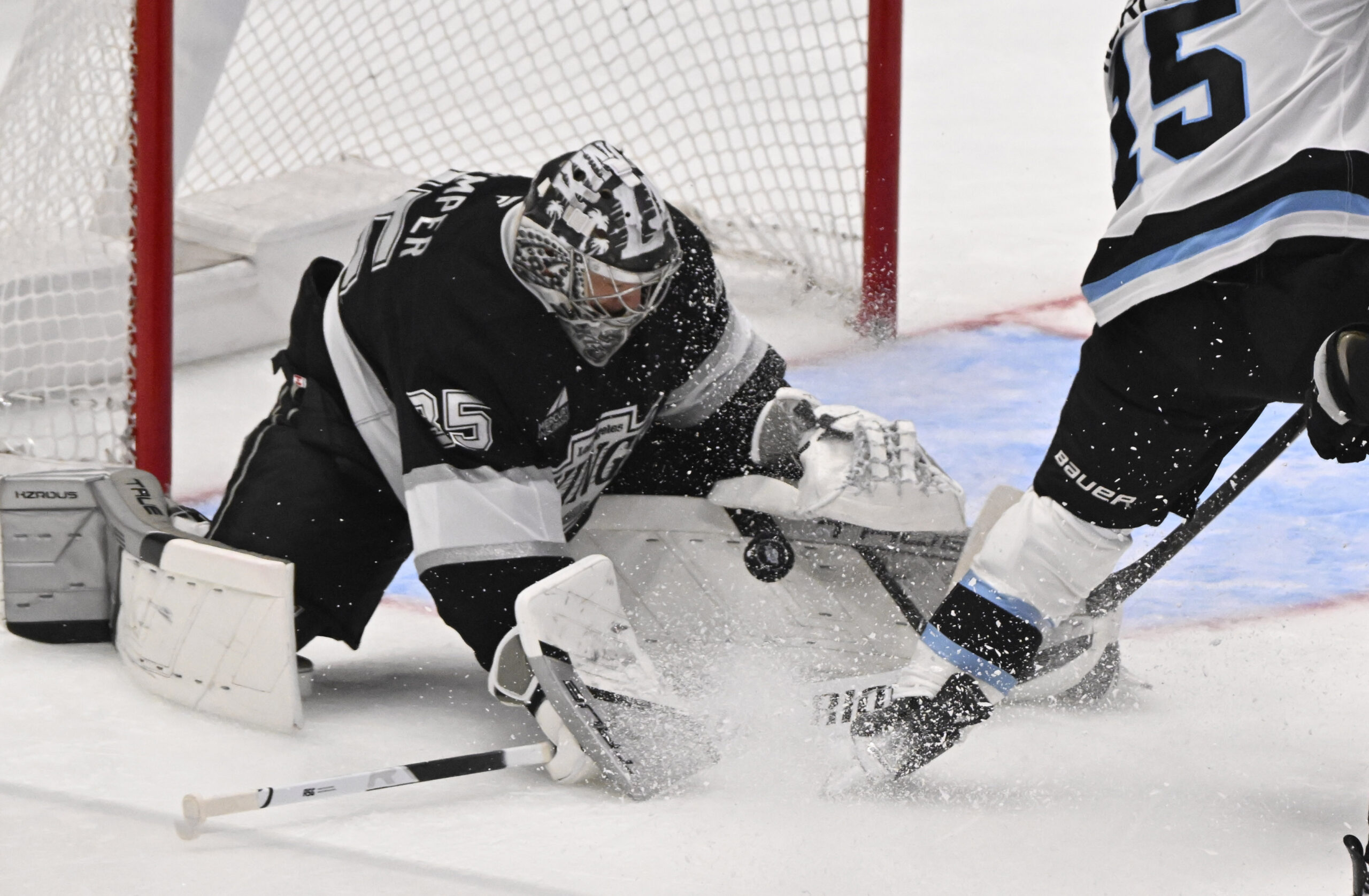 Goalie Darcy Kuemper #35 of the Kings blocks a shot...