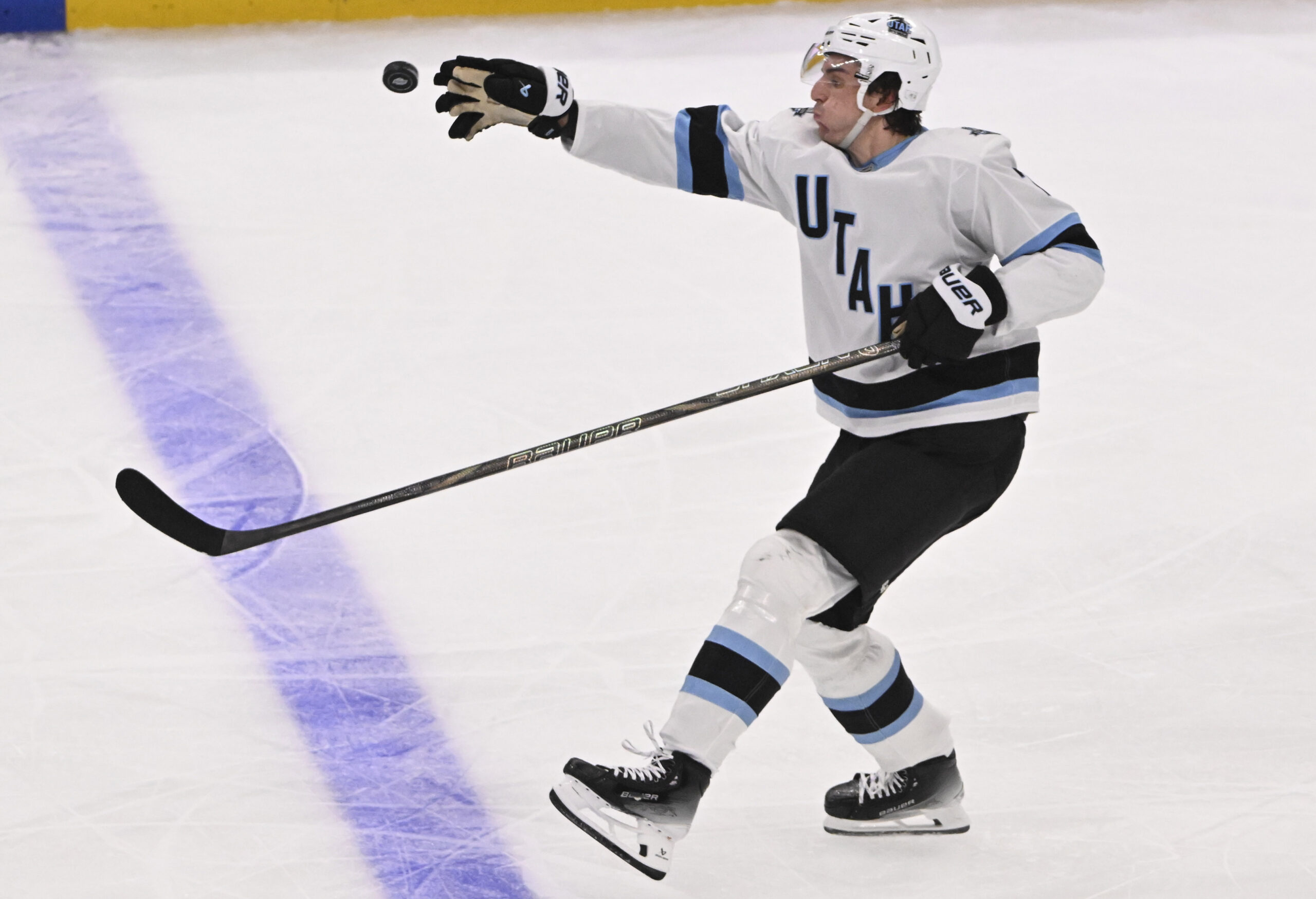 Michael Kesselring #7 of the Utah Hockey Club reaches for...