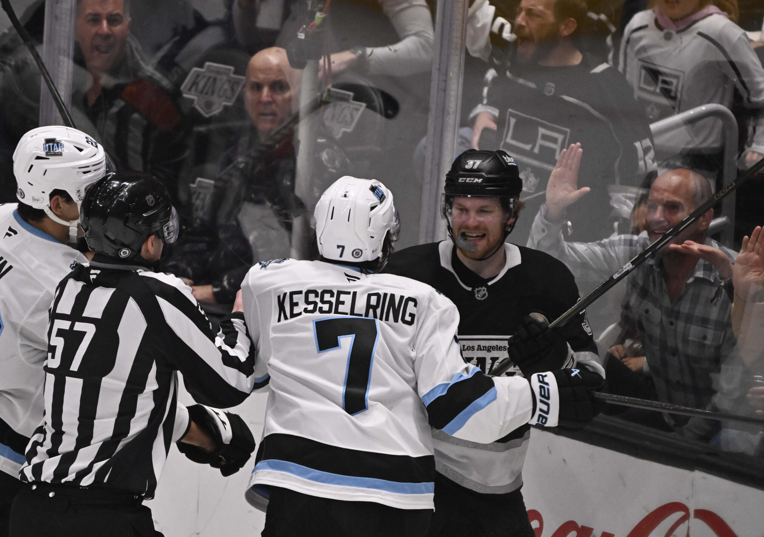 Warren Foegele #37 of the Kings tussles with Michael Kesselring...