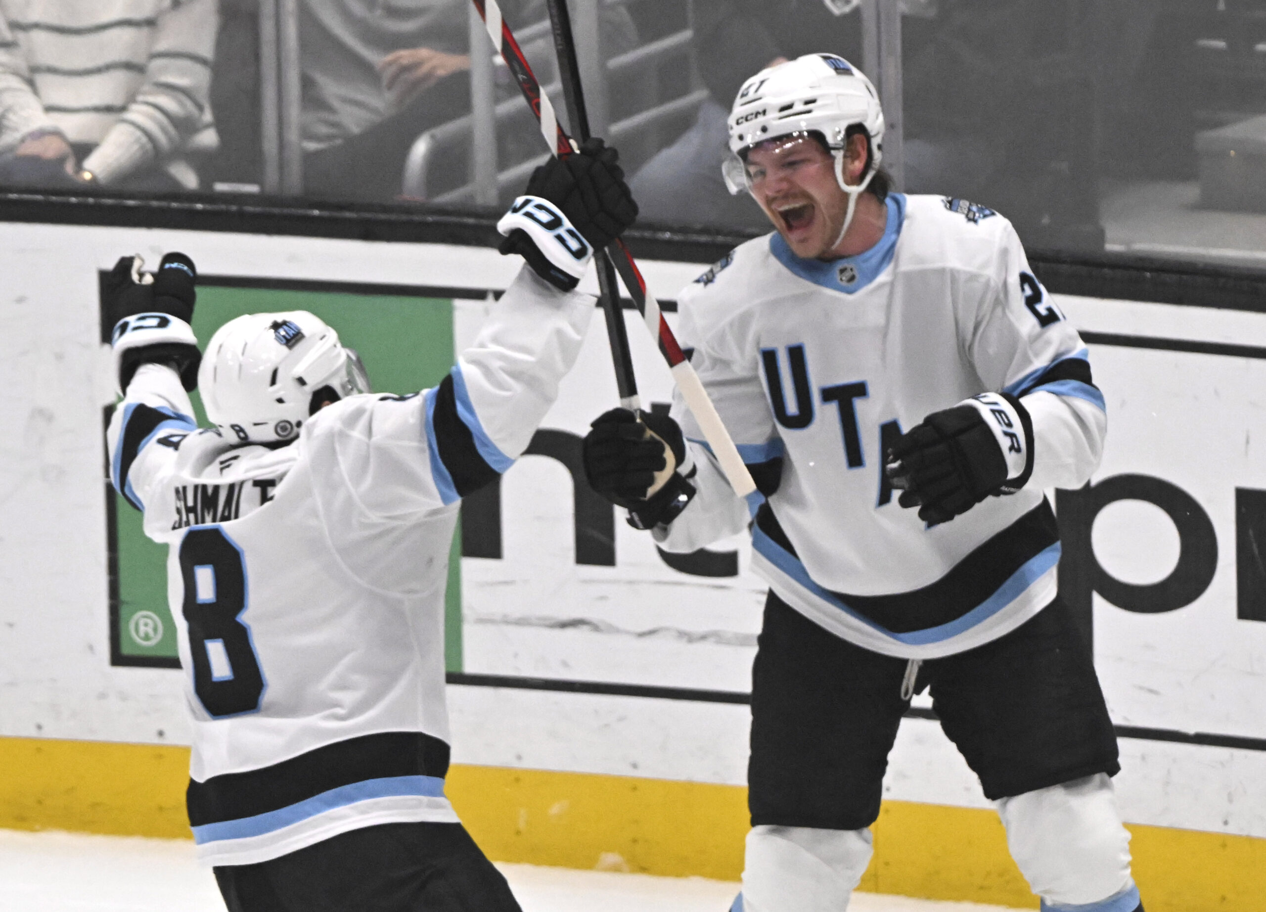 Barrett Hayton #27 celebrates with teammate Nick Schmaltz #8 of...