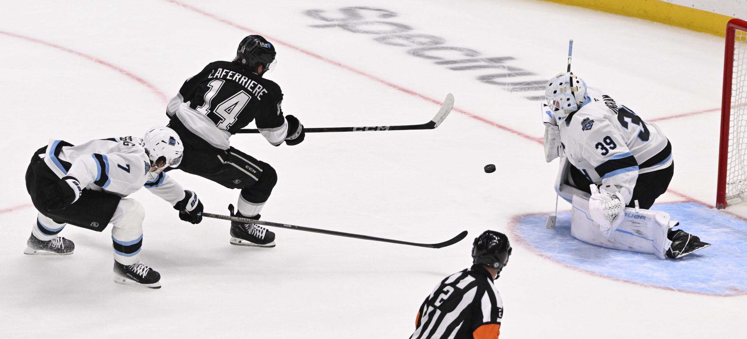 Alex Laferriere #14 of the Kings scores past goalie Connor...