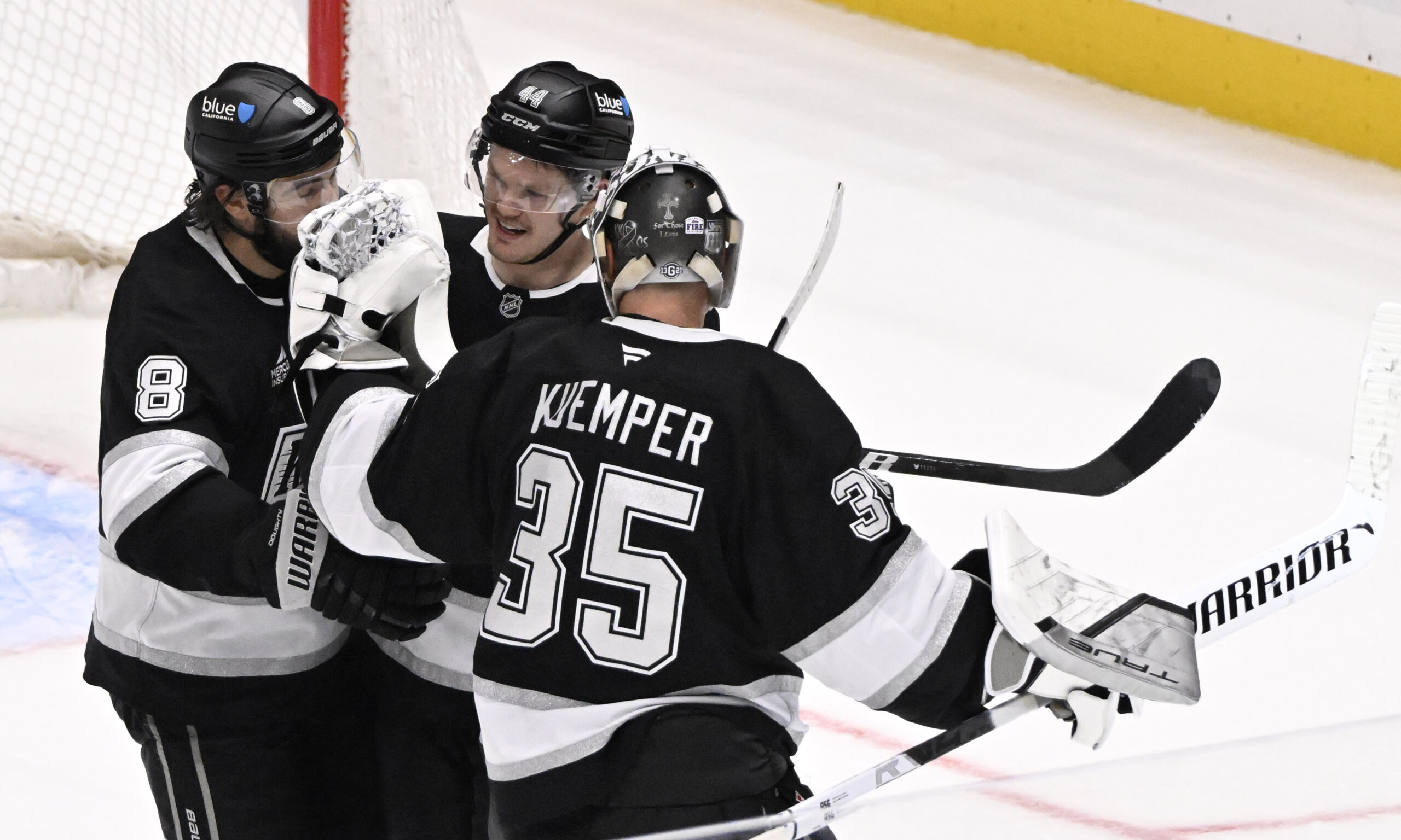 Mikey Anderson #44 celebrates with teammates Drew Doughty #8 and...