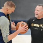 Denver Nuggets center Nikola Jokic (15) talks with head coach Michael Malone