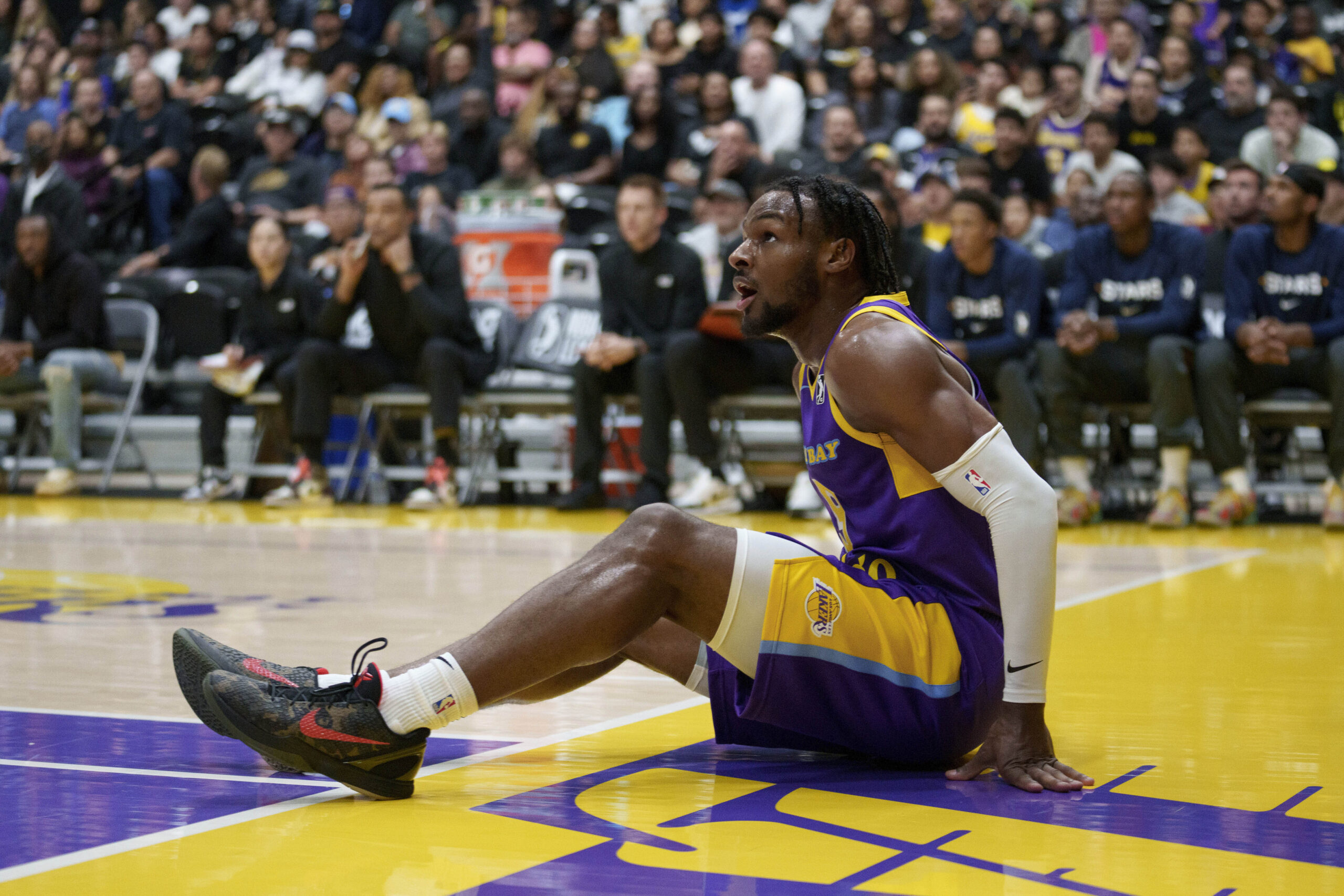 South Bay Lakers guard Bronny James gets up from the...