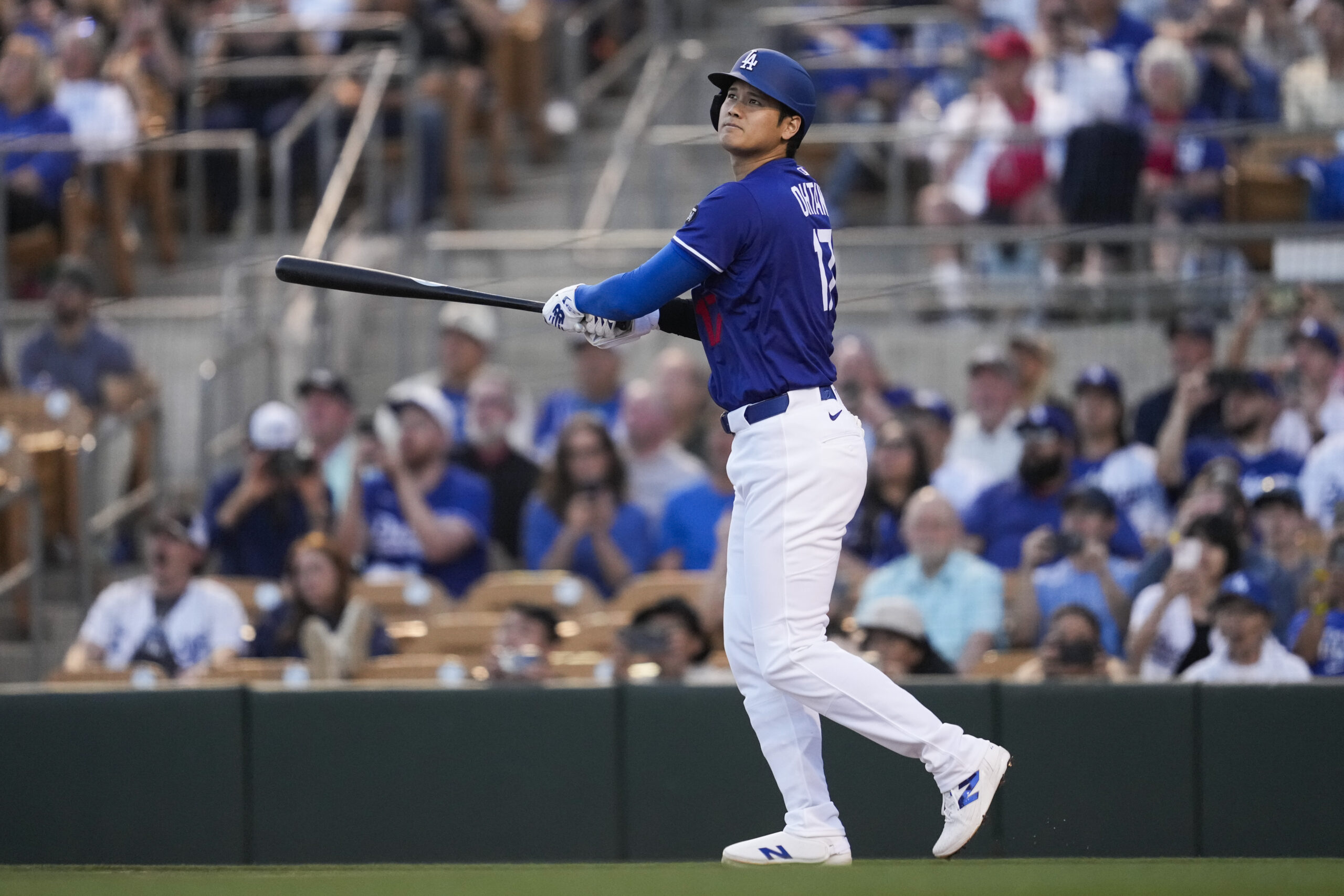 Dodgers designated hitter Shohei Ohtani watches the flight of his...