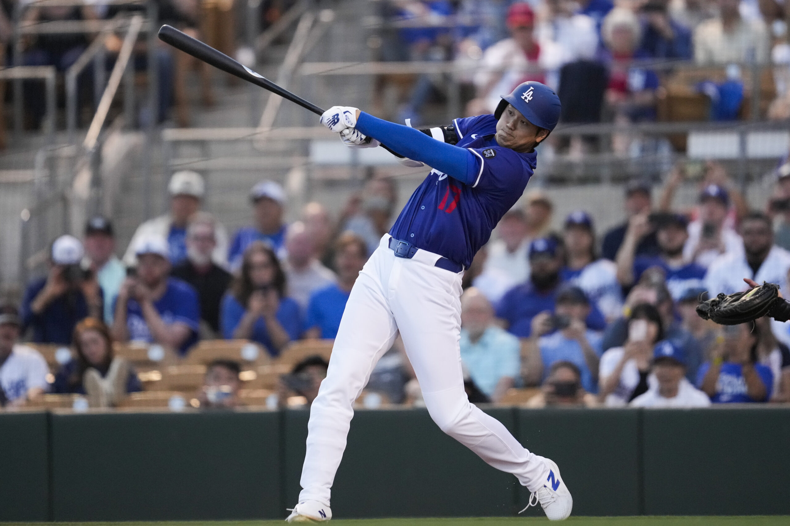 Dodgers designated hitter Shohei Ohtani hits a home run during...