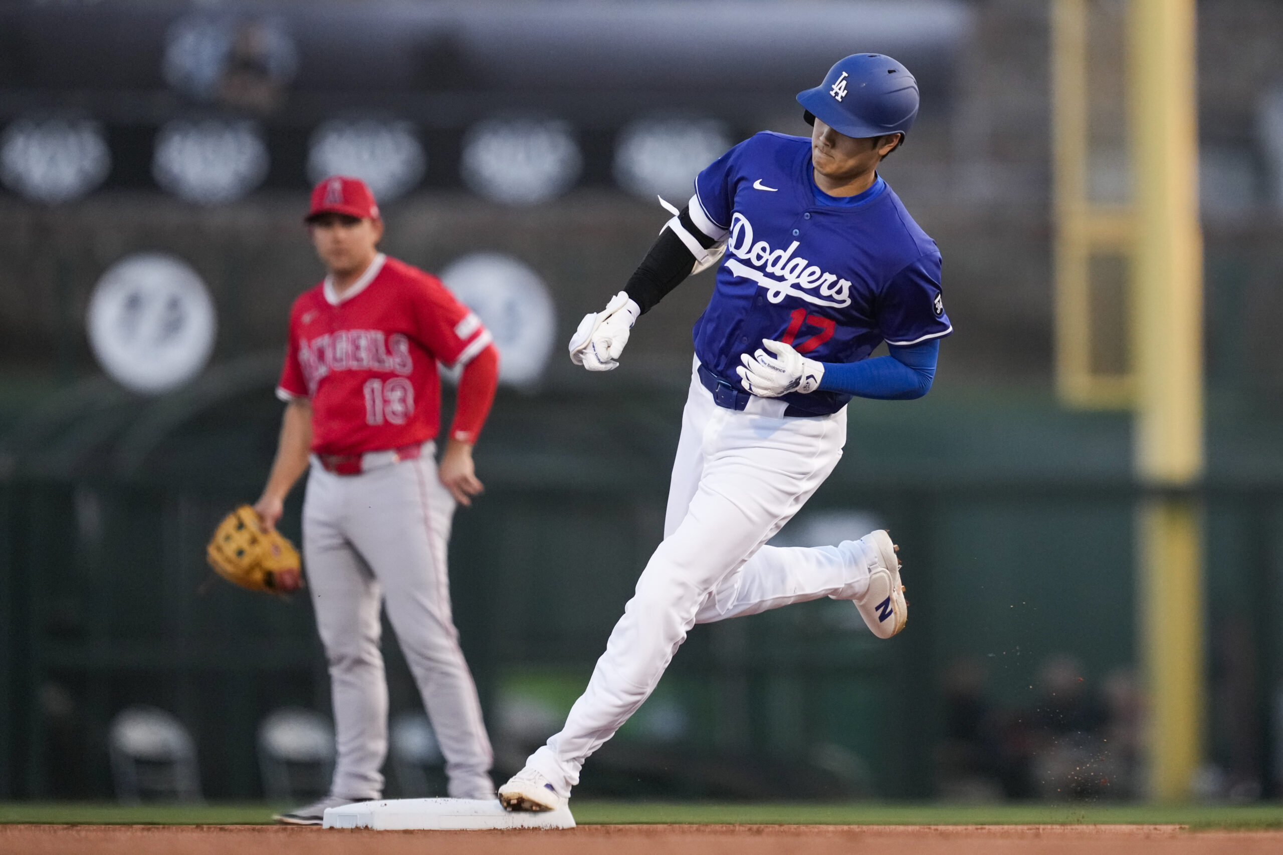 Dodgers designated hitter Shohei Ohtani runs the bases after hitting...