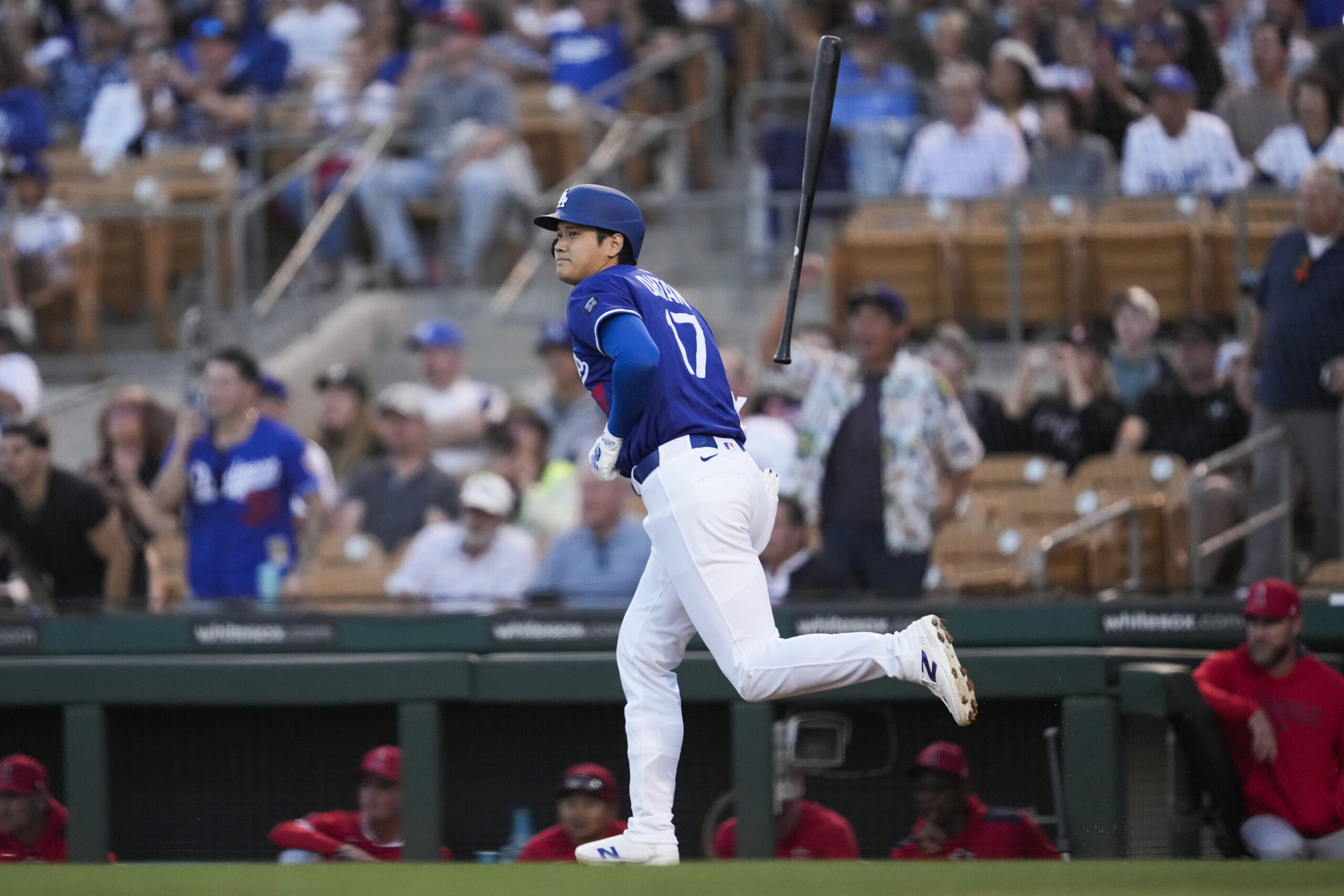 Dodgers designated hitter Shohei Ohtani tosses his bat as he...