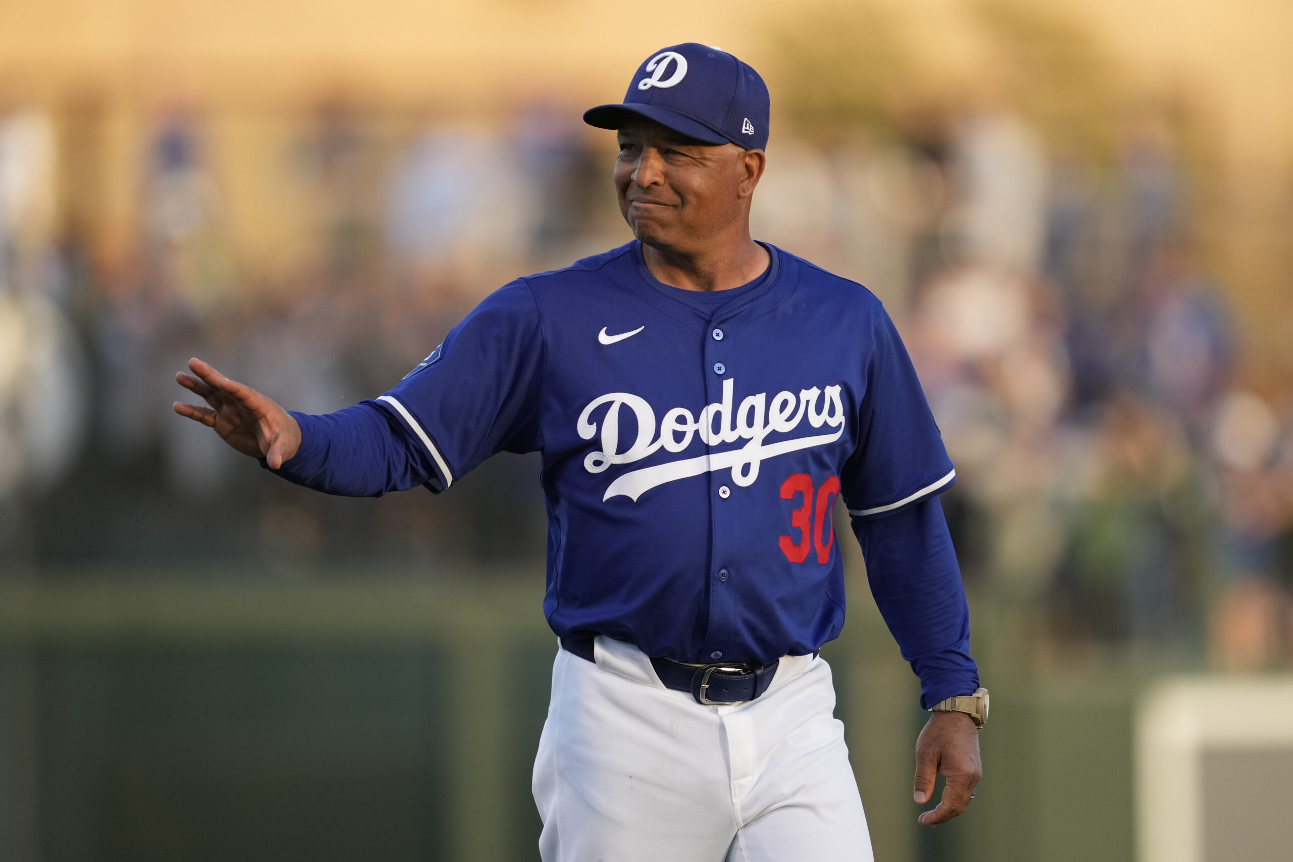 Dodgers manager Dave Roberts walks to the dugout before a...