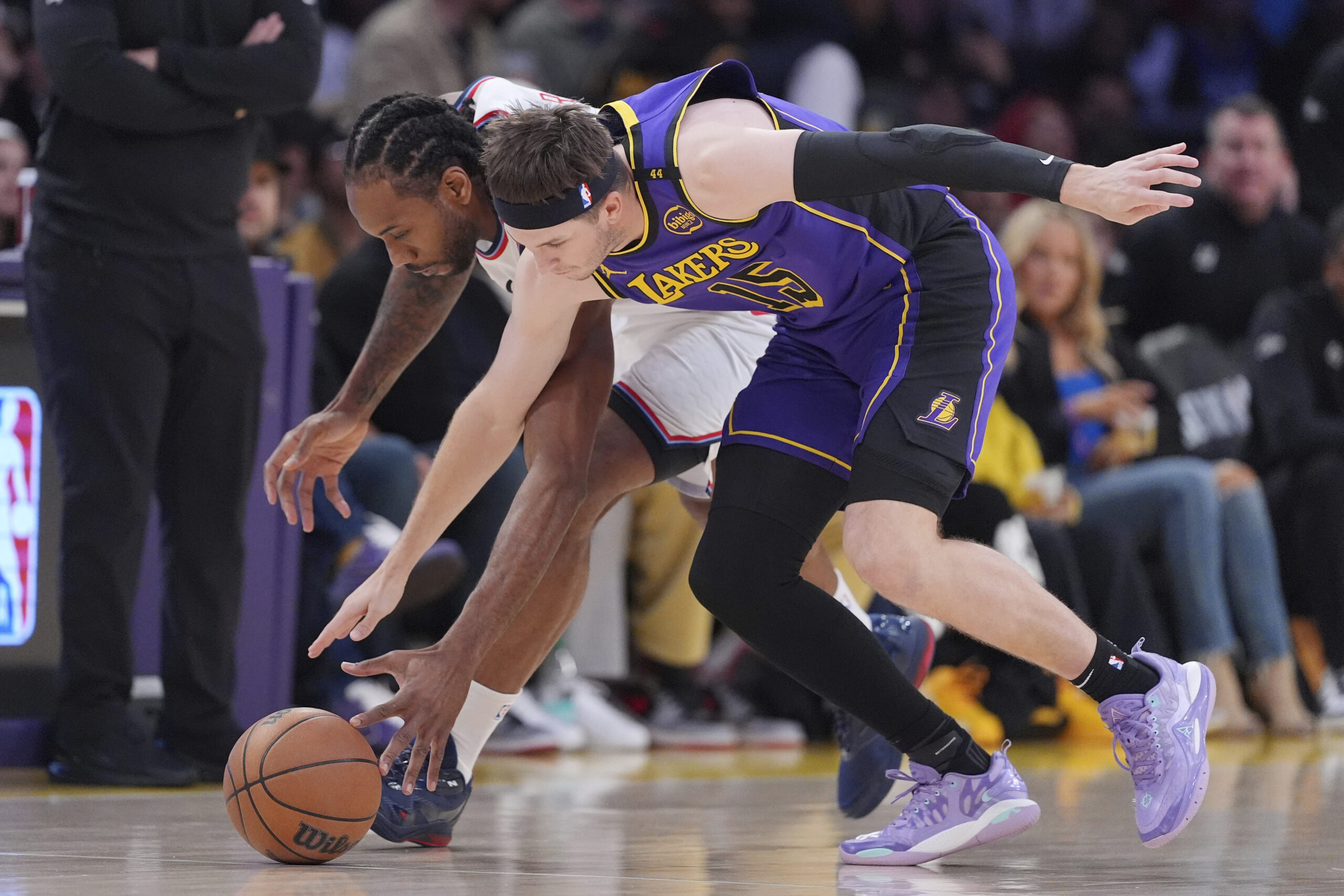 Clippers forward Kawhi Leonard, left, and Lakers guard Austin Reaves...