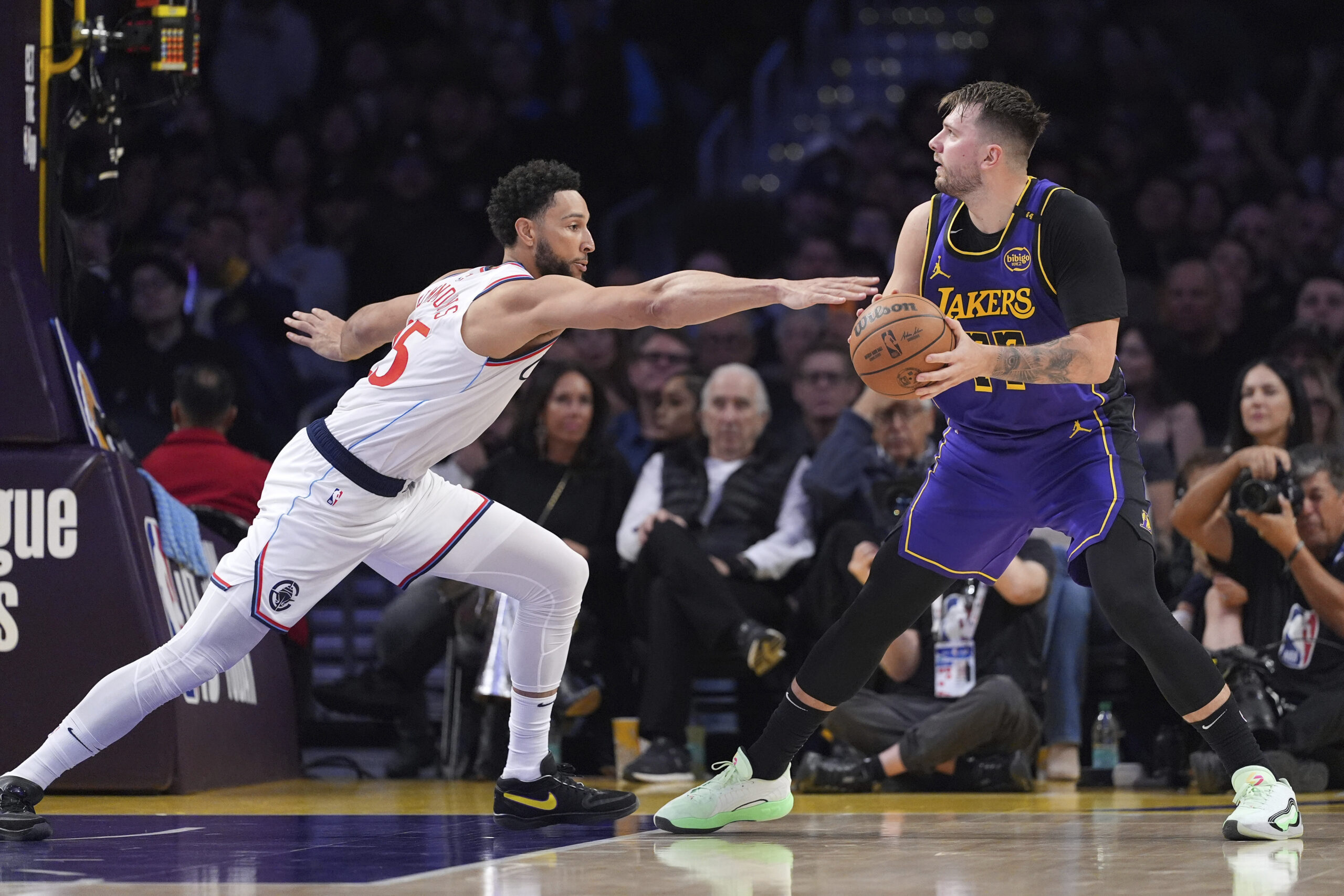 Clippers guard Ben Simmons, left, reaches in on Lakers guard...