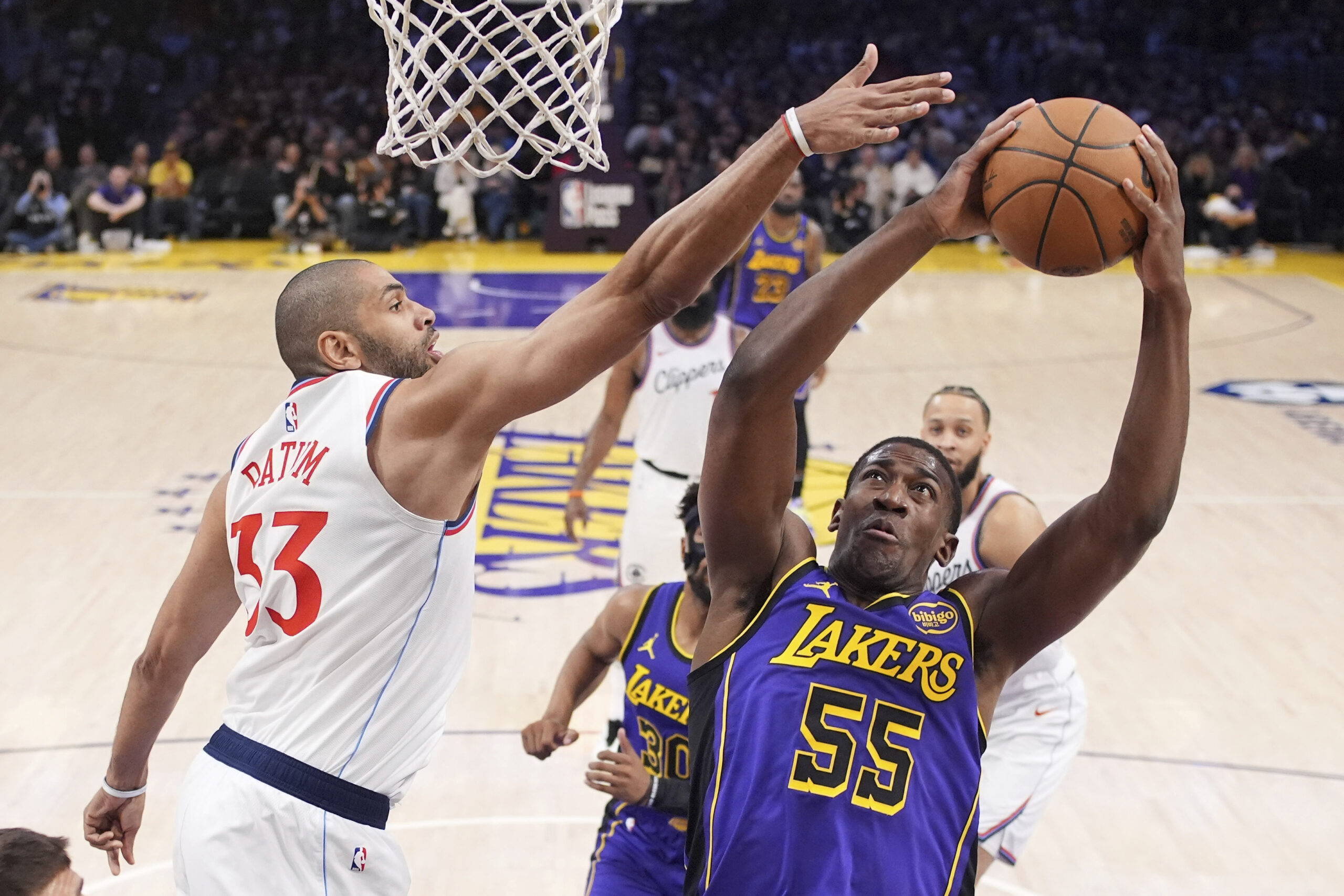 Lakers center Trey Jemison III, right, shoots as Clippers forward...