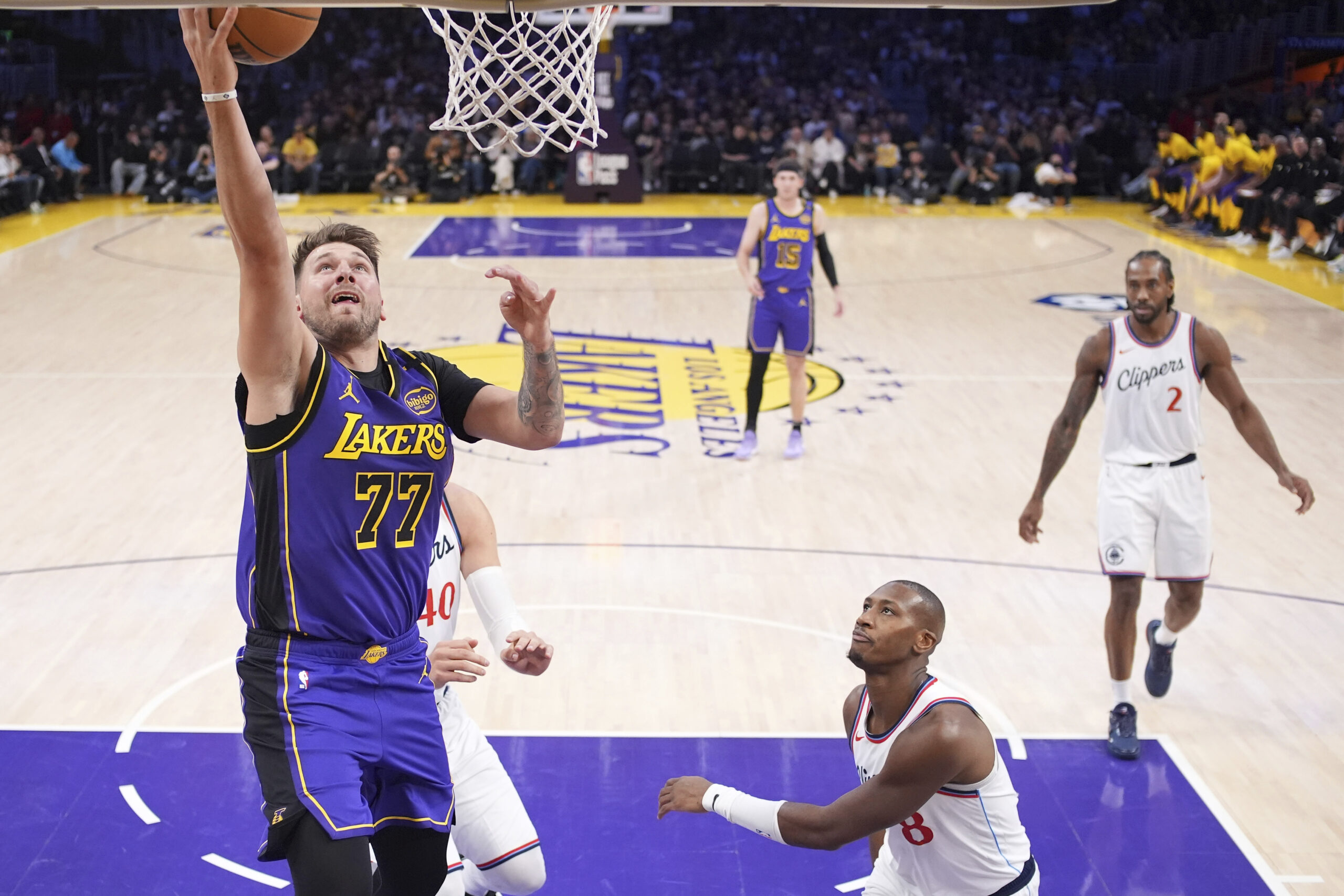 Lakers guard Luka Doncic (77) shoots as Clippers guard Kris...