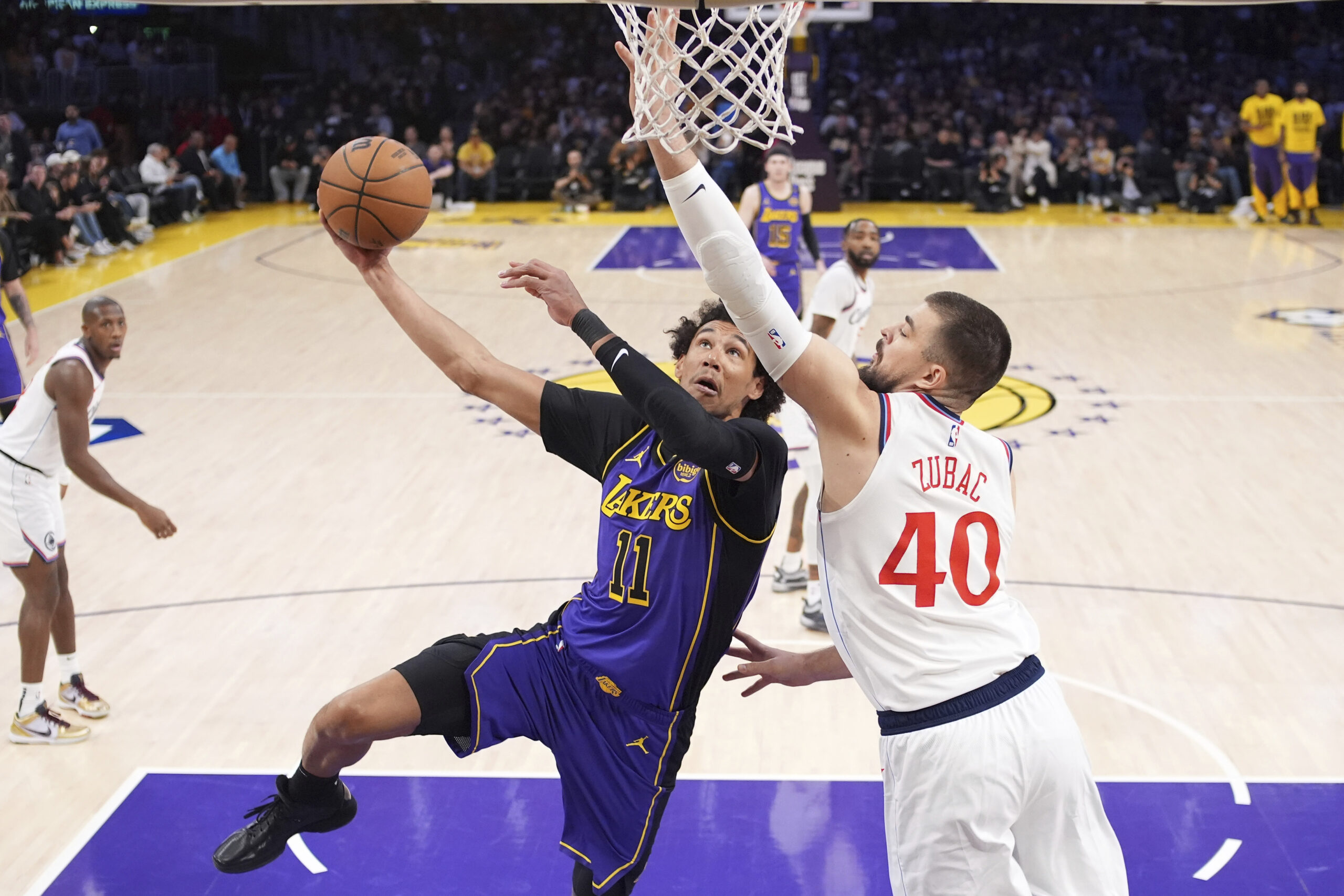 Lakers center Jaxson Hayes (11) goes up for a dunk...