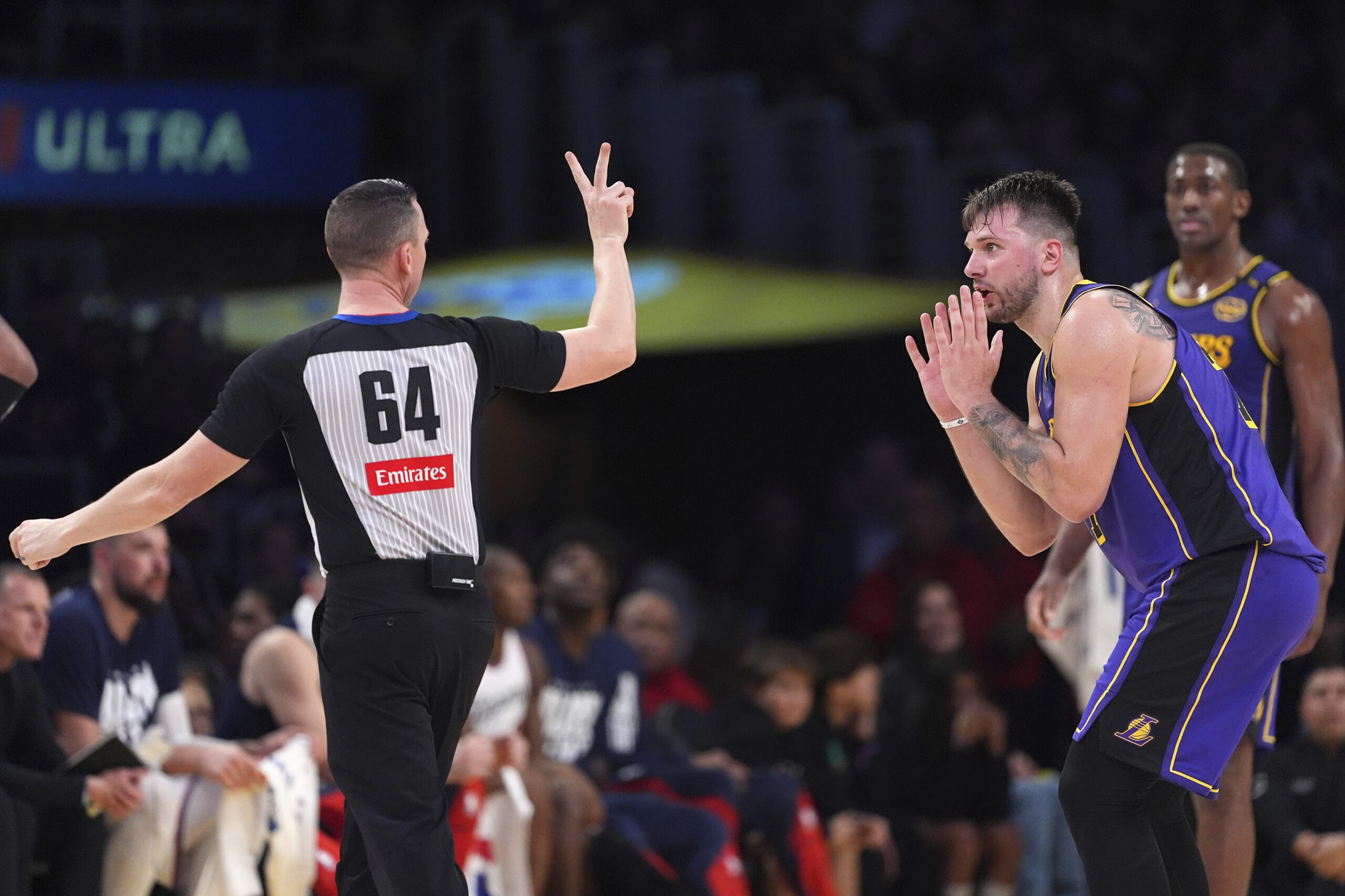 Lakers guard Luka Doncic, right, reacts as he is called...