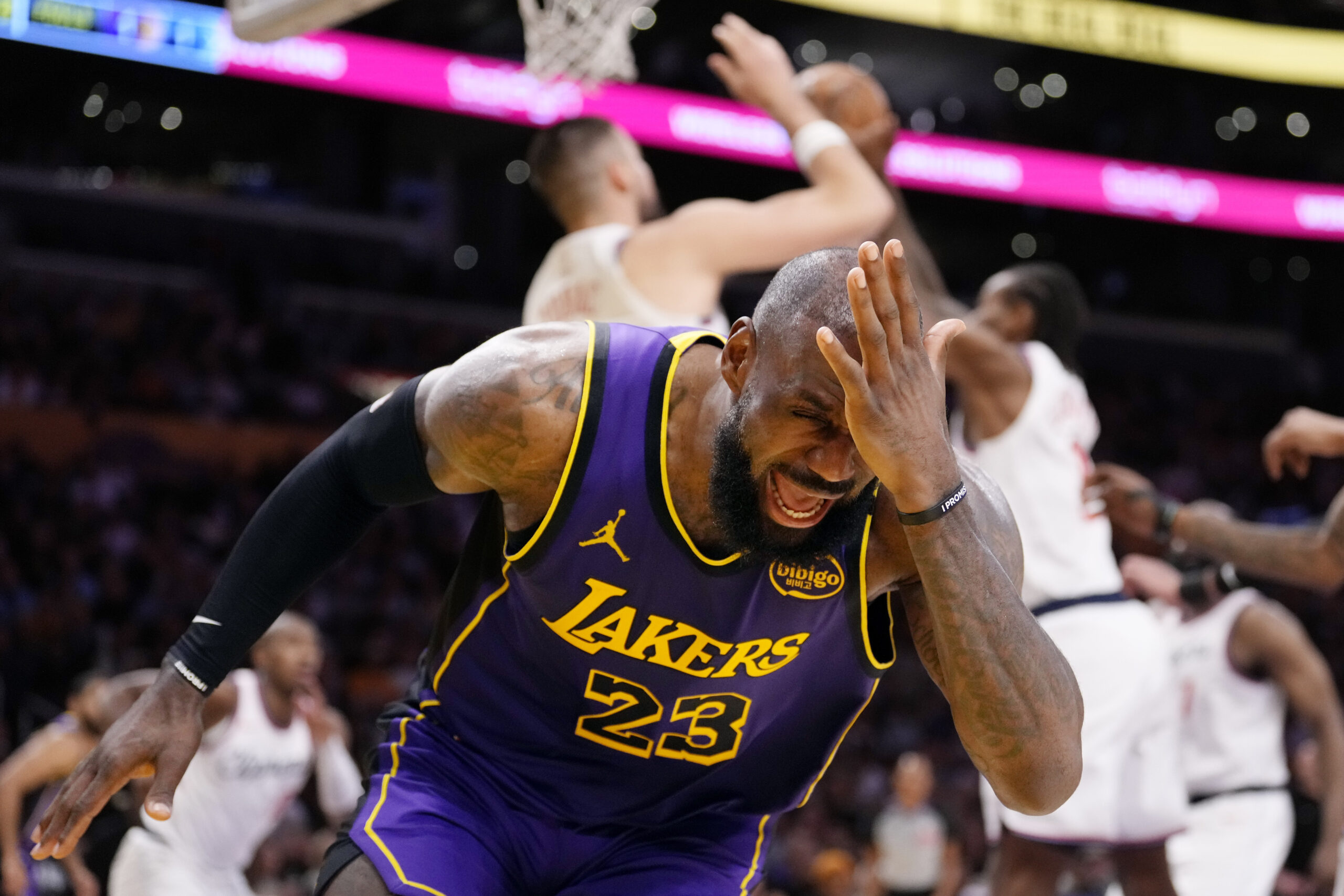 Lakers forward LeBron James reacts after being hit in the...