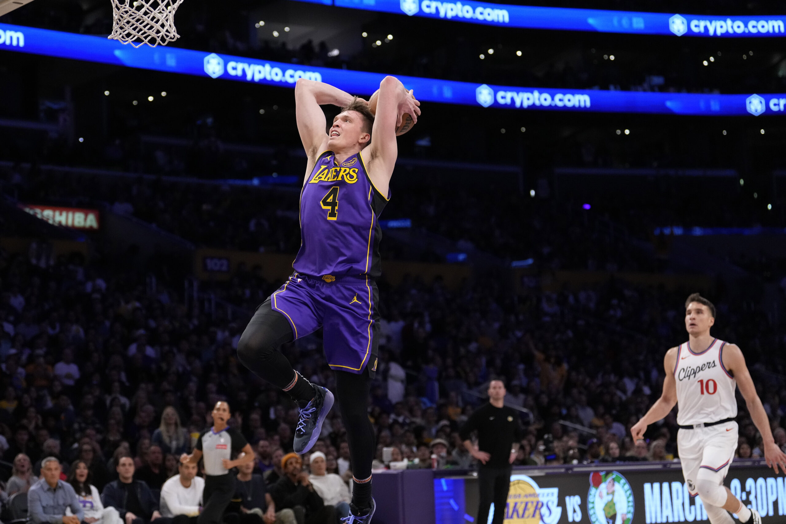 Lakers rookie guard Dalton Knecht, left, goes up for a...