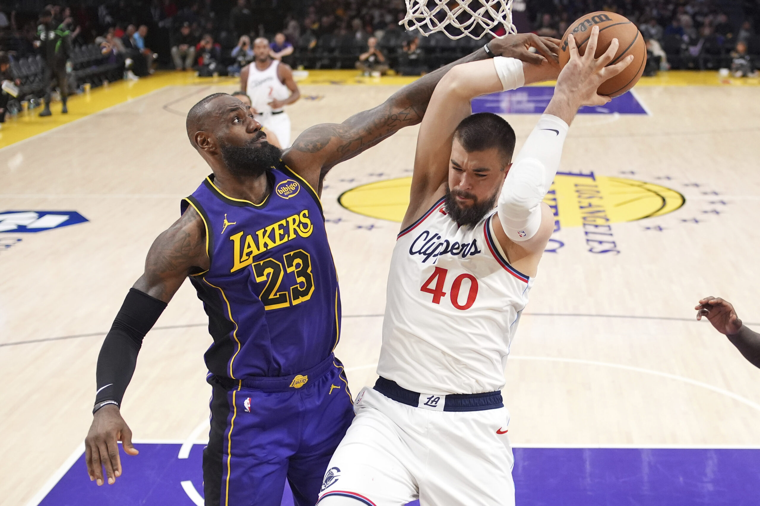 Clippers center Ivica Zubac, right, tries to shoot as Lakers...