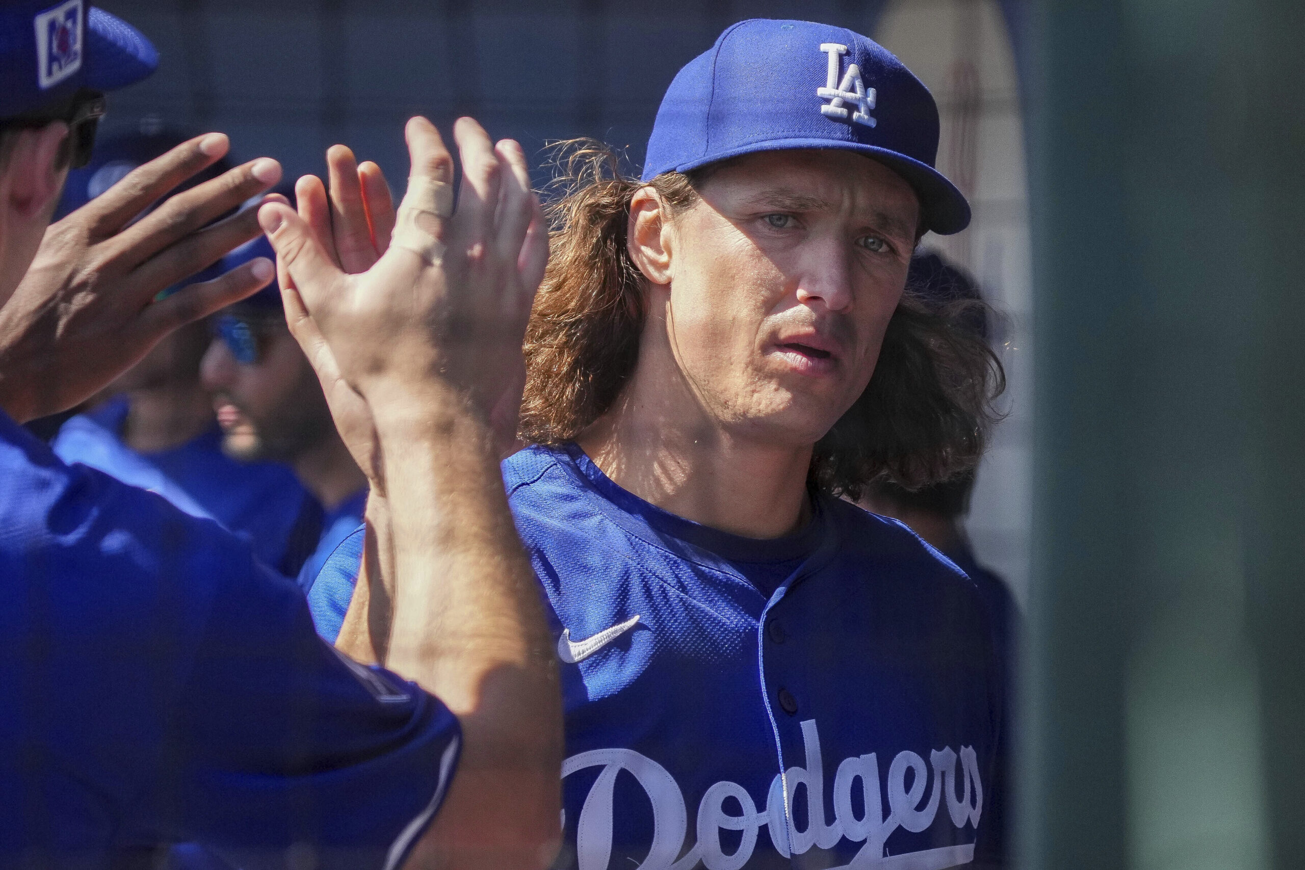 Dodgers pitcher Tyler Glasnow gets high-fives from the dugout after...