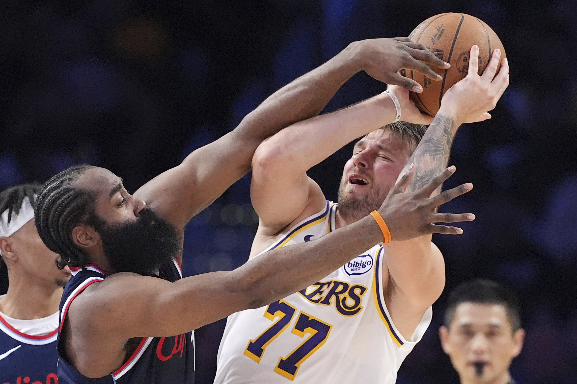 Lakers guard Luka Doncic, right, tries to pass while under...