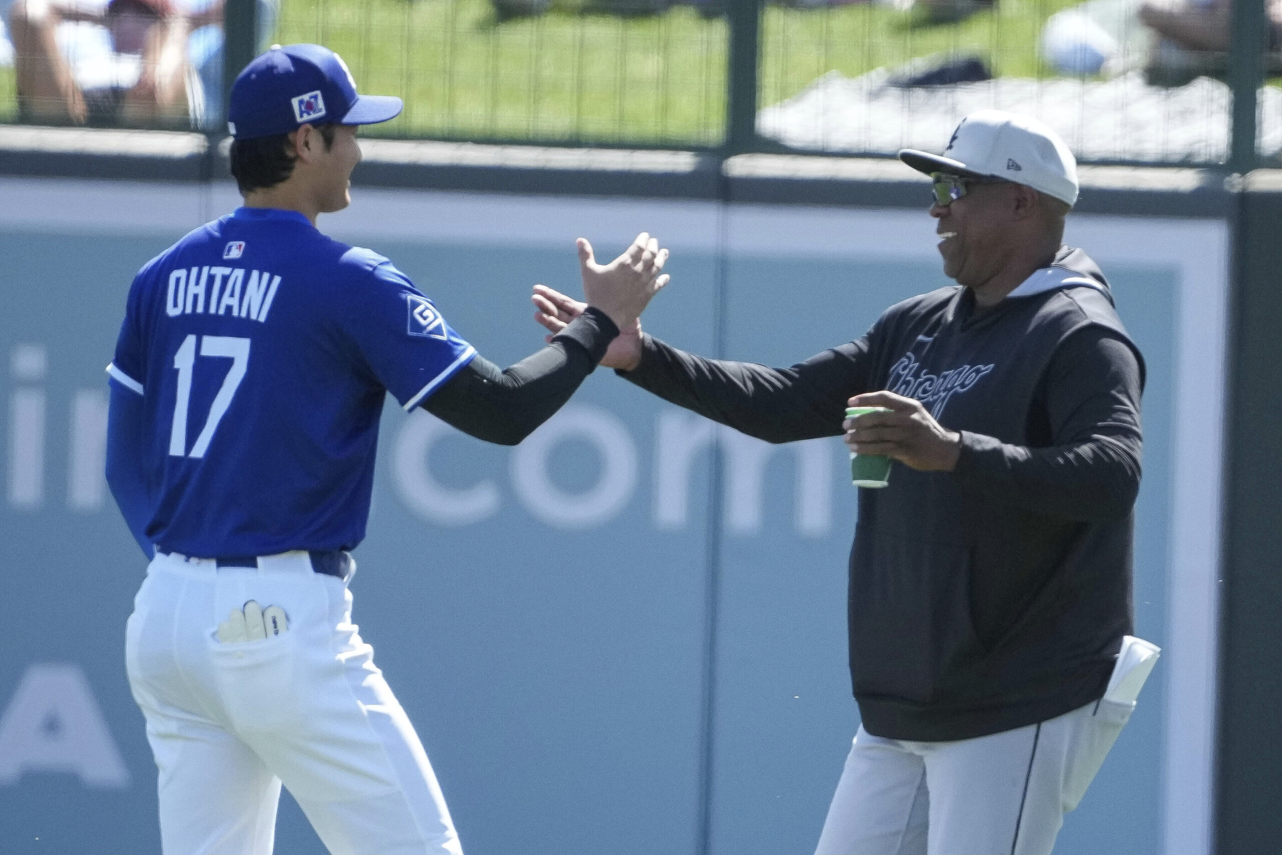 Dodgers two-way player Shohei Ohtani (17) greets his old hitting...