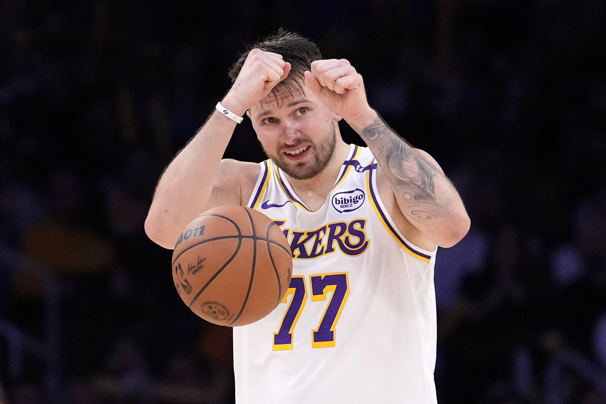 Lakers guard Luka Doncic gestures to teammates as he dribbles...