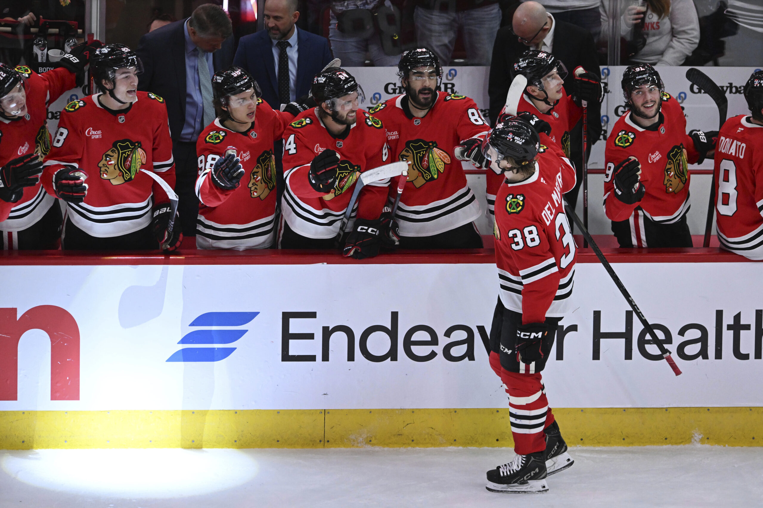 The Chicago Blackhawks’ Ethan Del Mastro (38) celebrates with teammates...