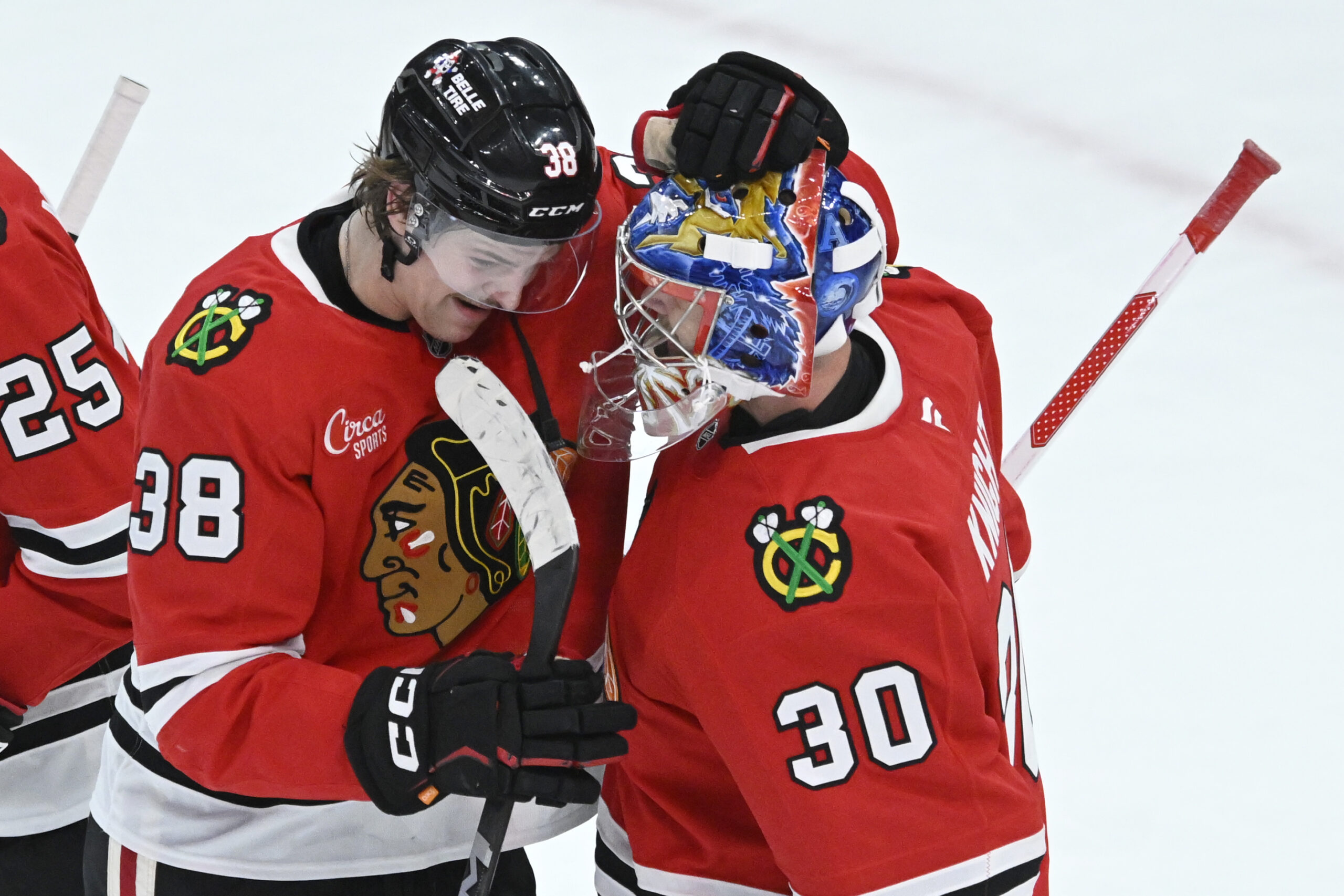 Chicago Blackhawks goalie Spencer Knight, right, celebrates with teammate Ethan...