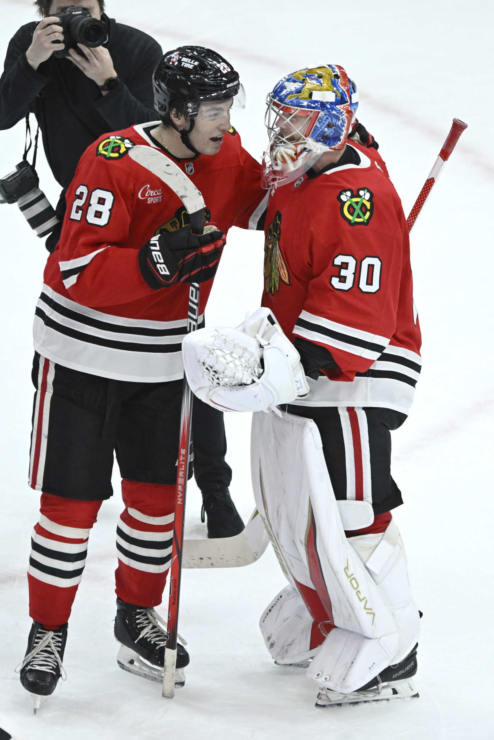 Chicago Blackhawks goalie Spencer Knight, right, celebrates with teammate Colton...