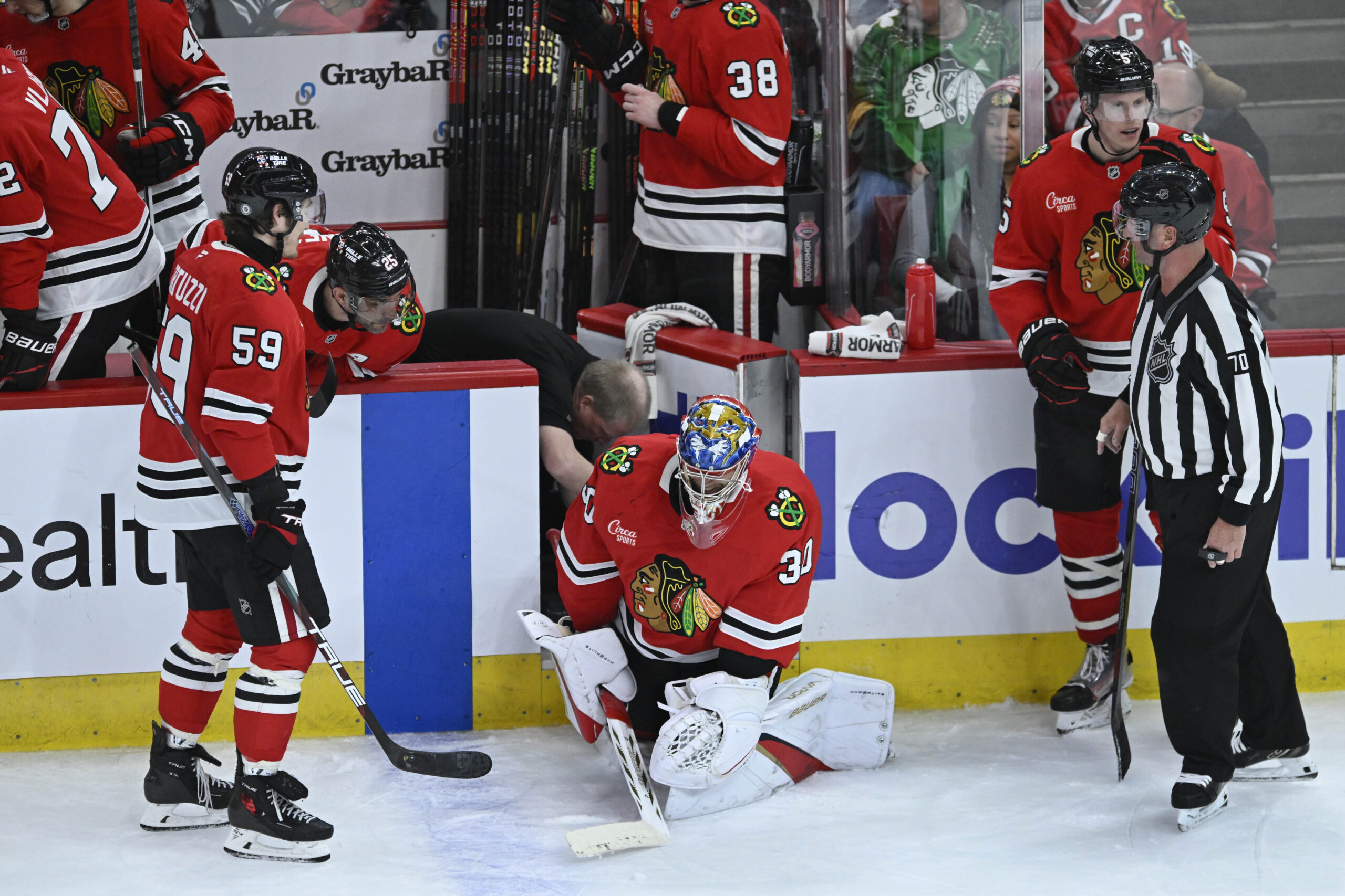 Chicago Blackhawks goalie Spencer Knight (30) has a broken blade...